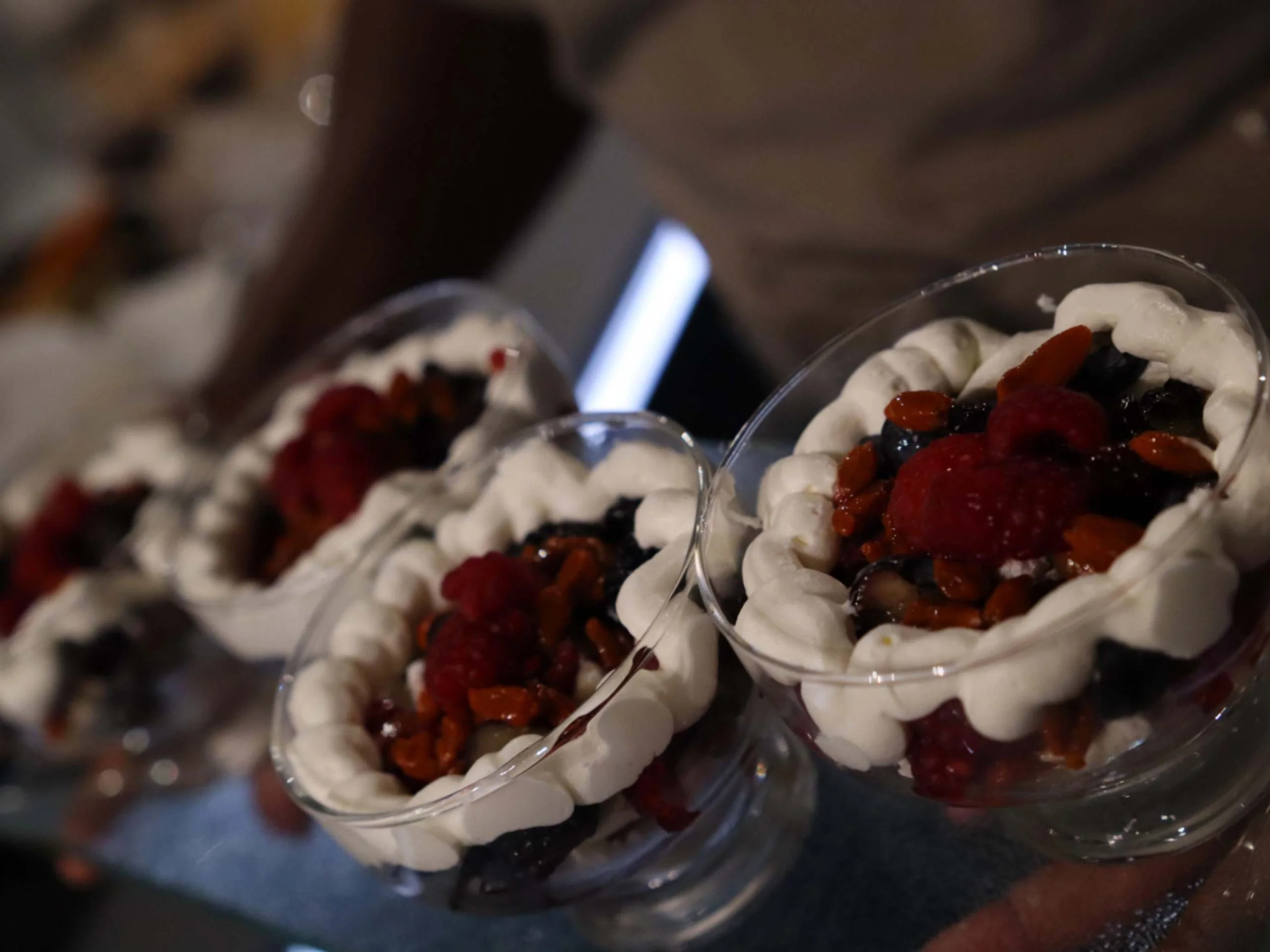 Individual berry and cream desserts with raspberries, blueberries and crisp meringue.