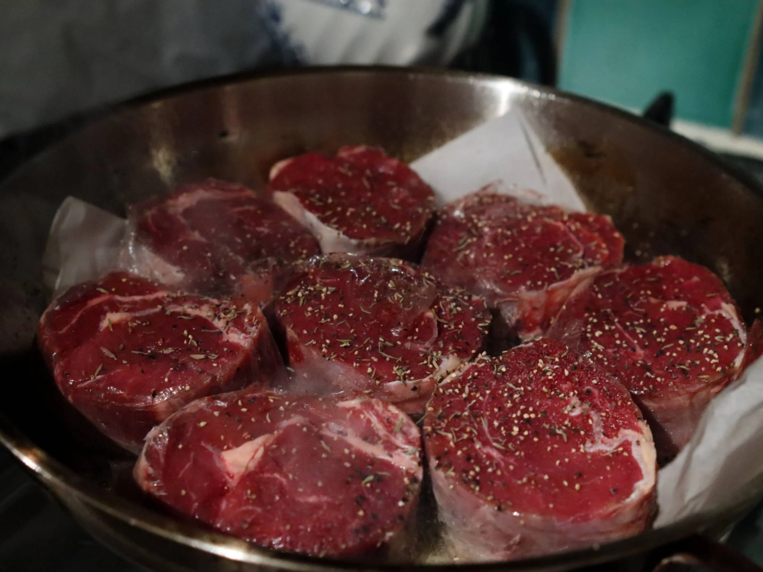 Seasoned cuts of meat ready for cooking during a Greek Tings private dining event.
