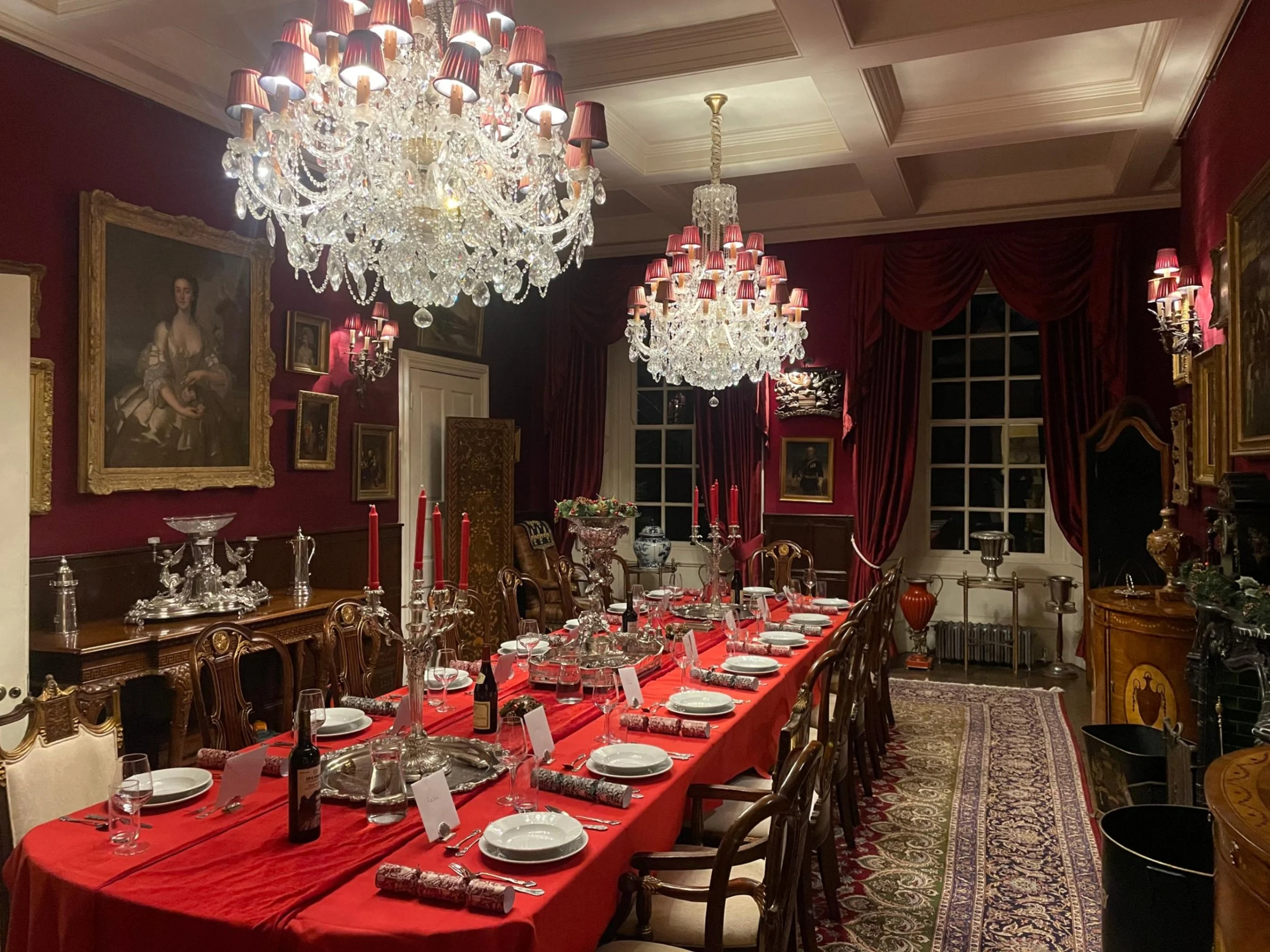 Formal table setting in a mansion, chandeliers, candles, wine on table, fine dining, corporate event, christmas dinner