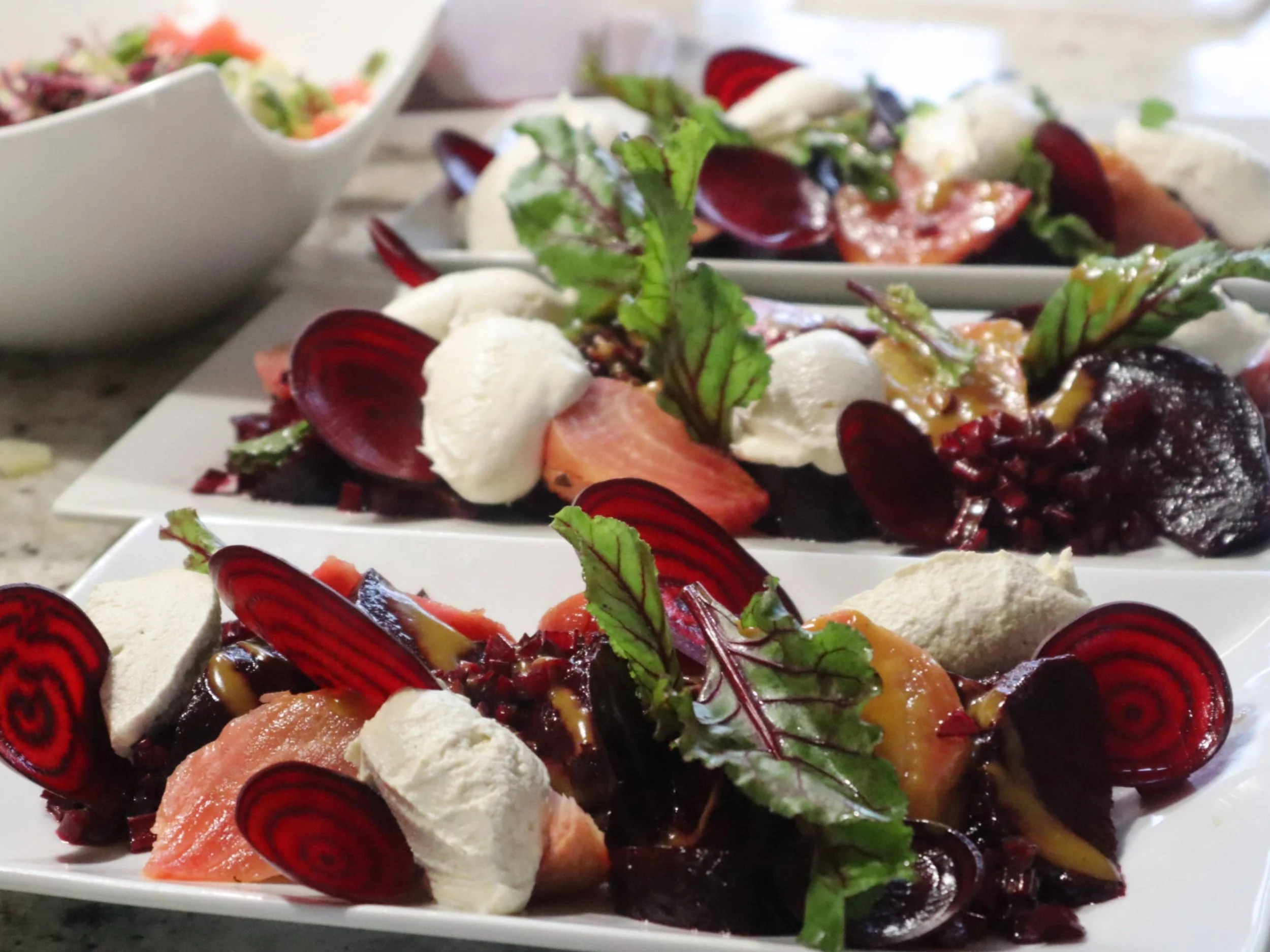 Colourful beetroot starter with greens, creamy garnish using the whole root vegetable