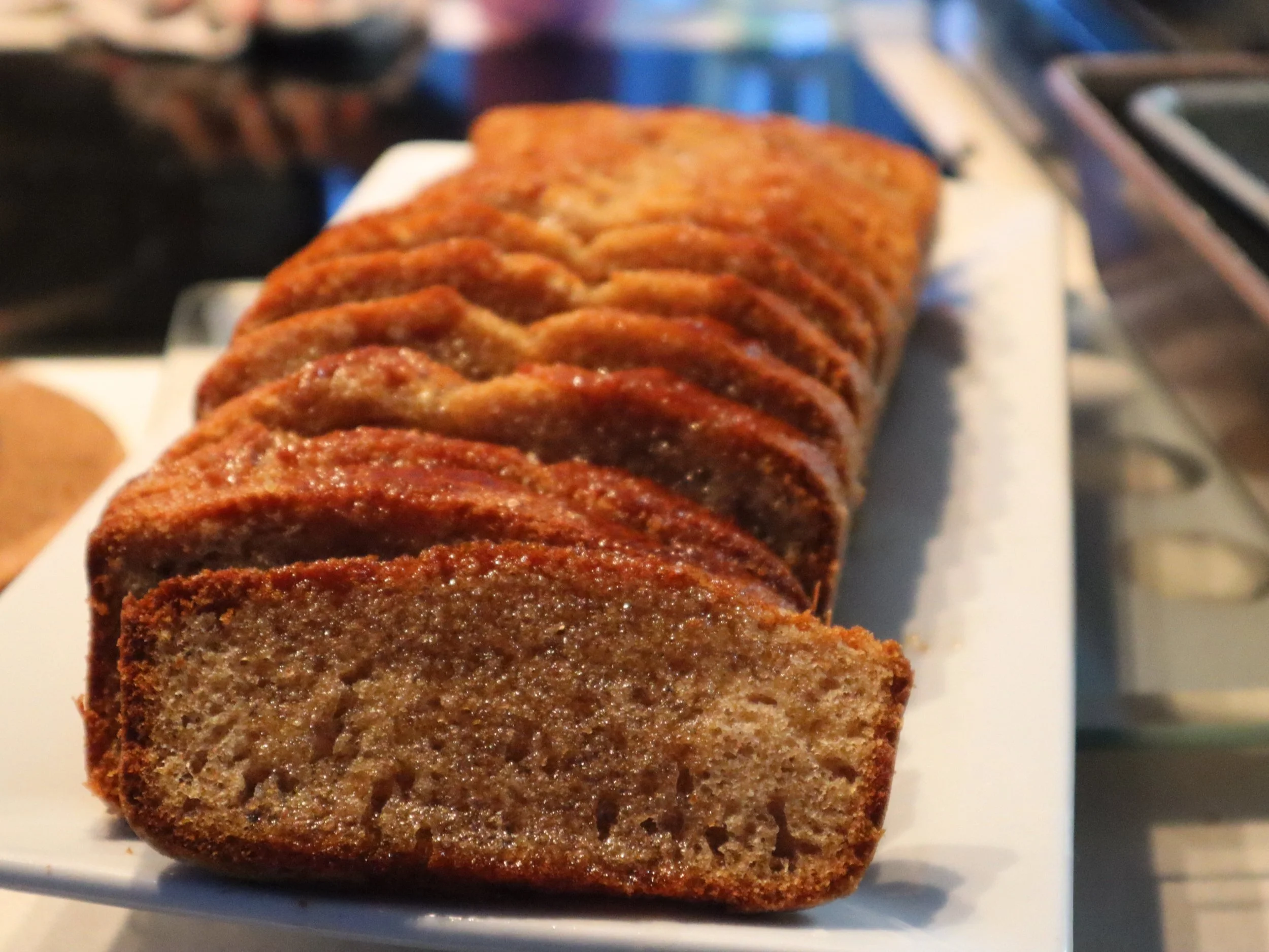  Slices of moist Jamaican-style loaf cake arranged on a serving platter.
