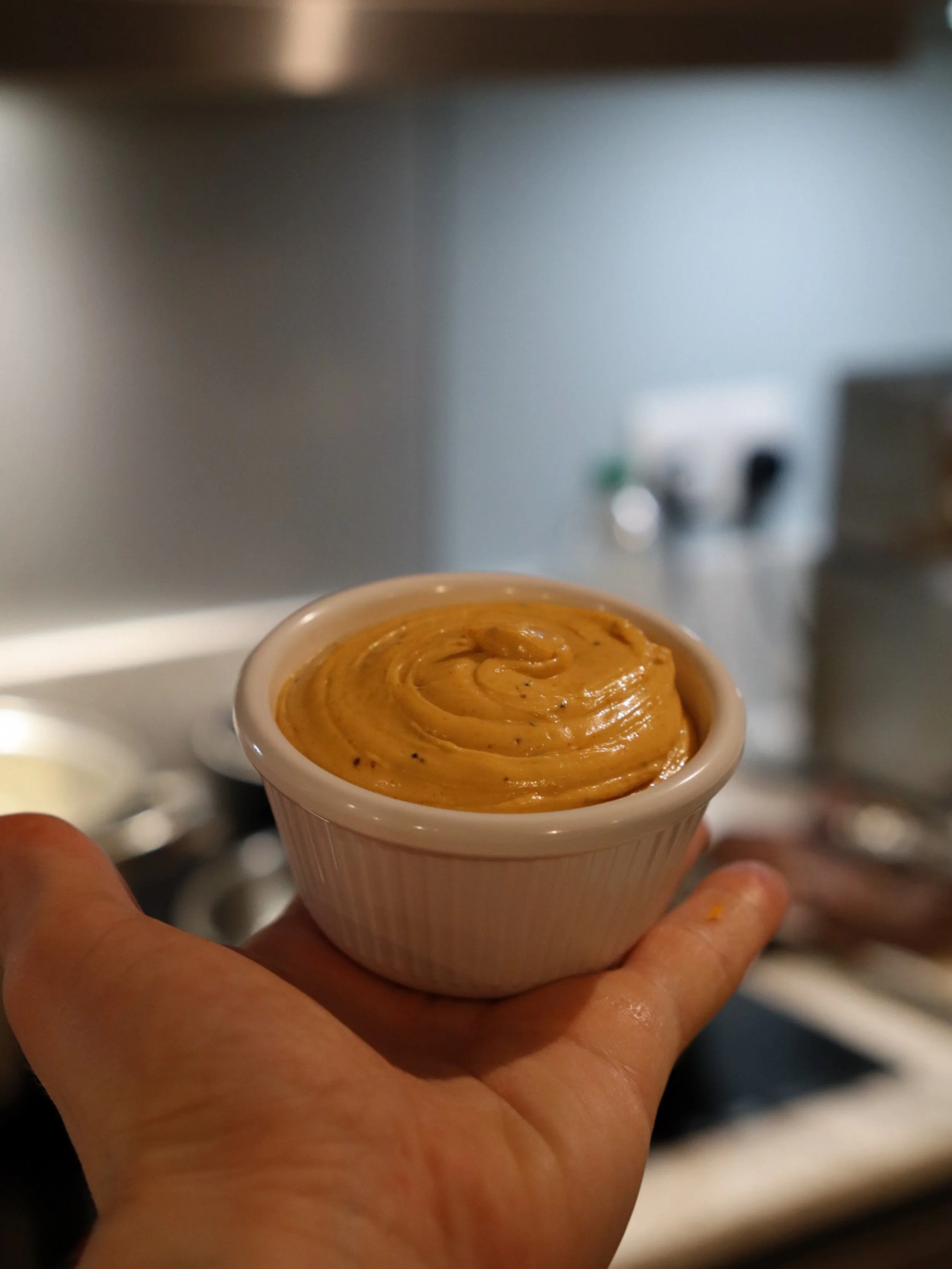 Creamy orange spiced dipping sauce served in a ramekin at a Greek Tings event.