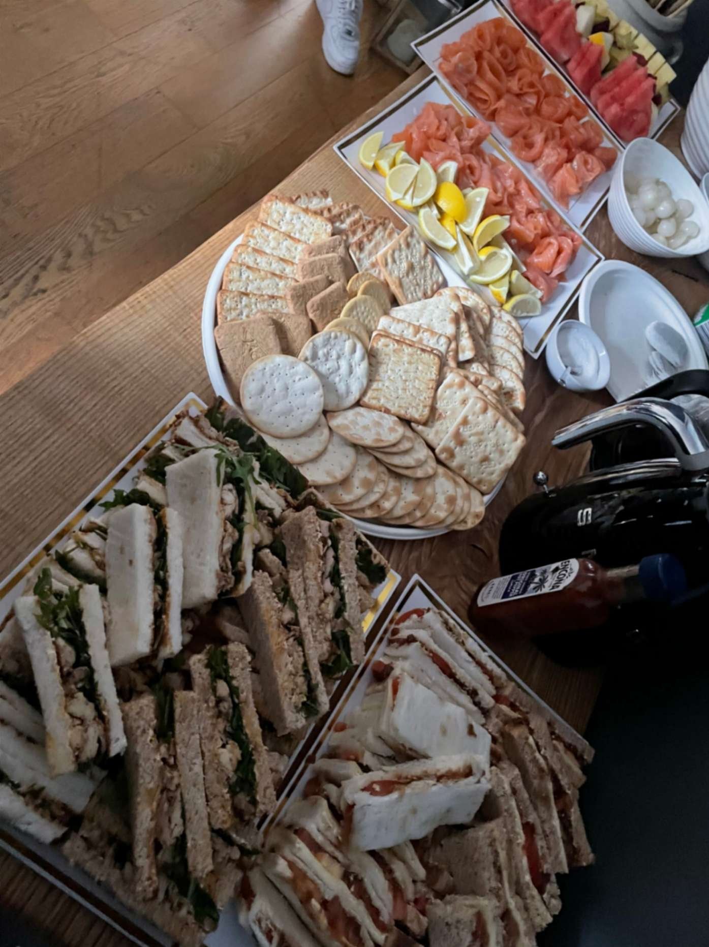 Cold buffet with finger sandwiches, smoked salmon, crackers, fruit and small sharing dishes.
