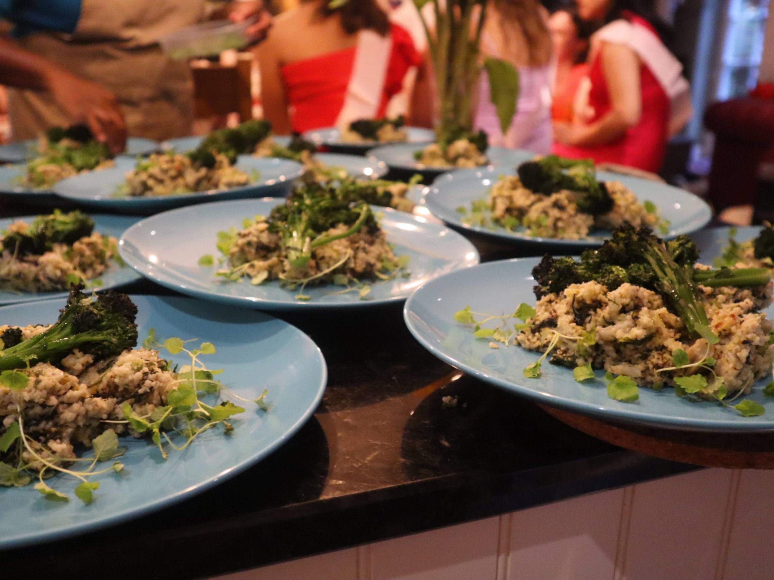 Plated Italian risotto-style dishes with charred broccoli and micro herbs ready for service.