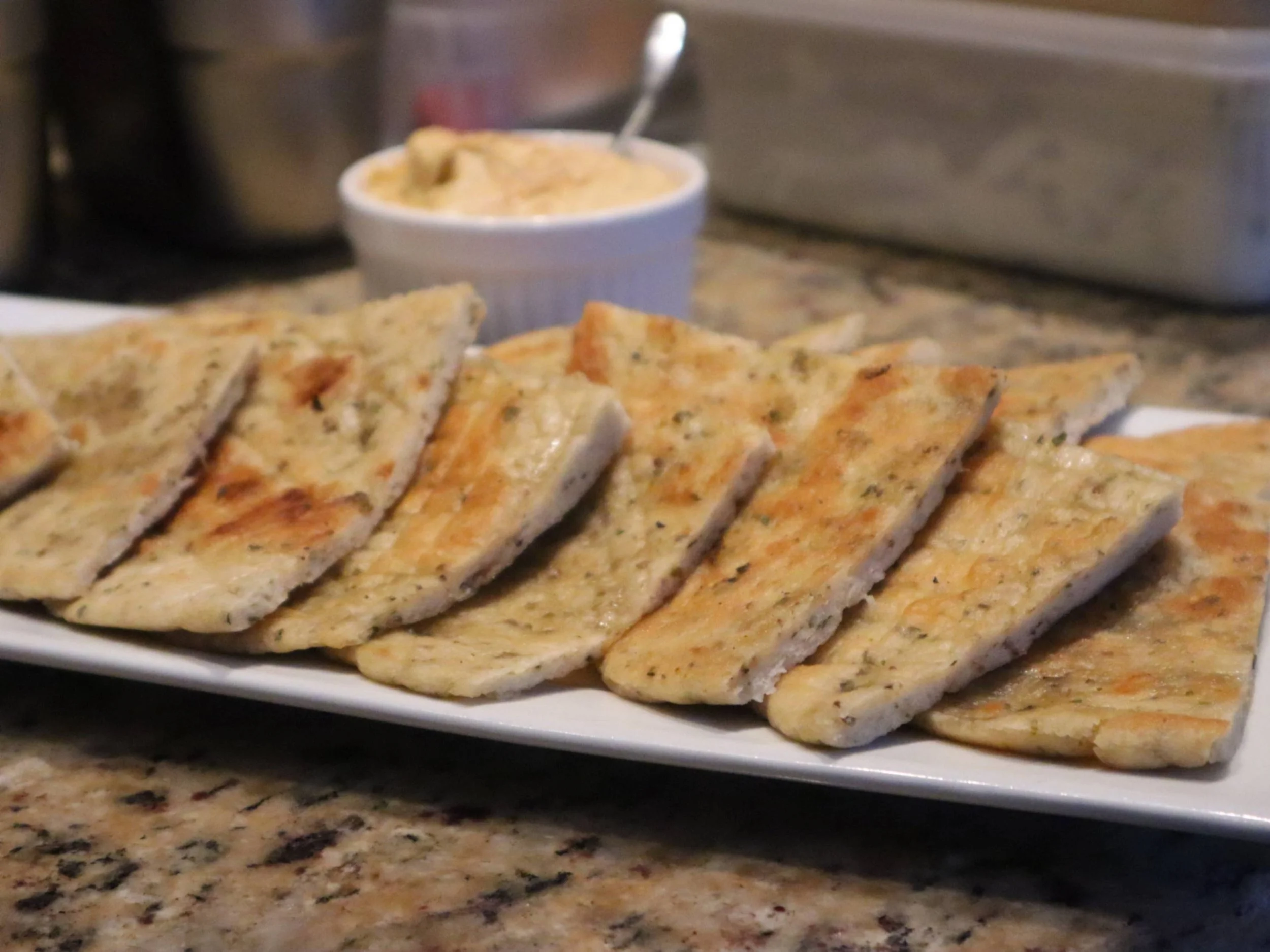 Fresh homemade Greek pita bread brushed with olive oil, oregano and salt.
