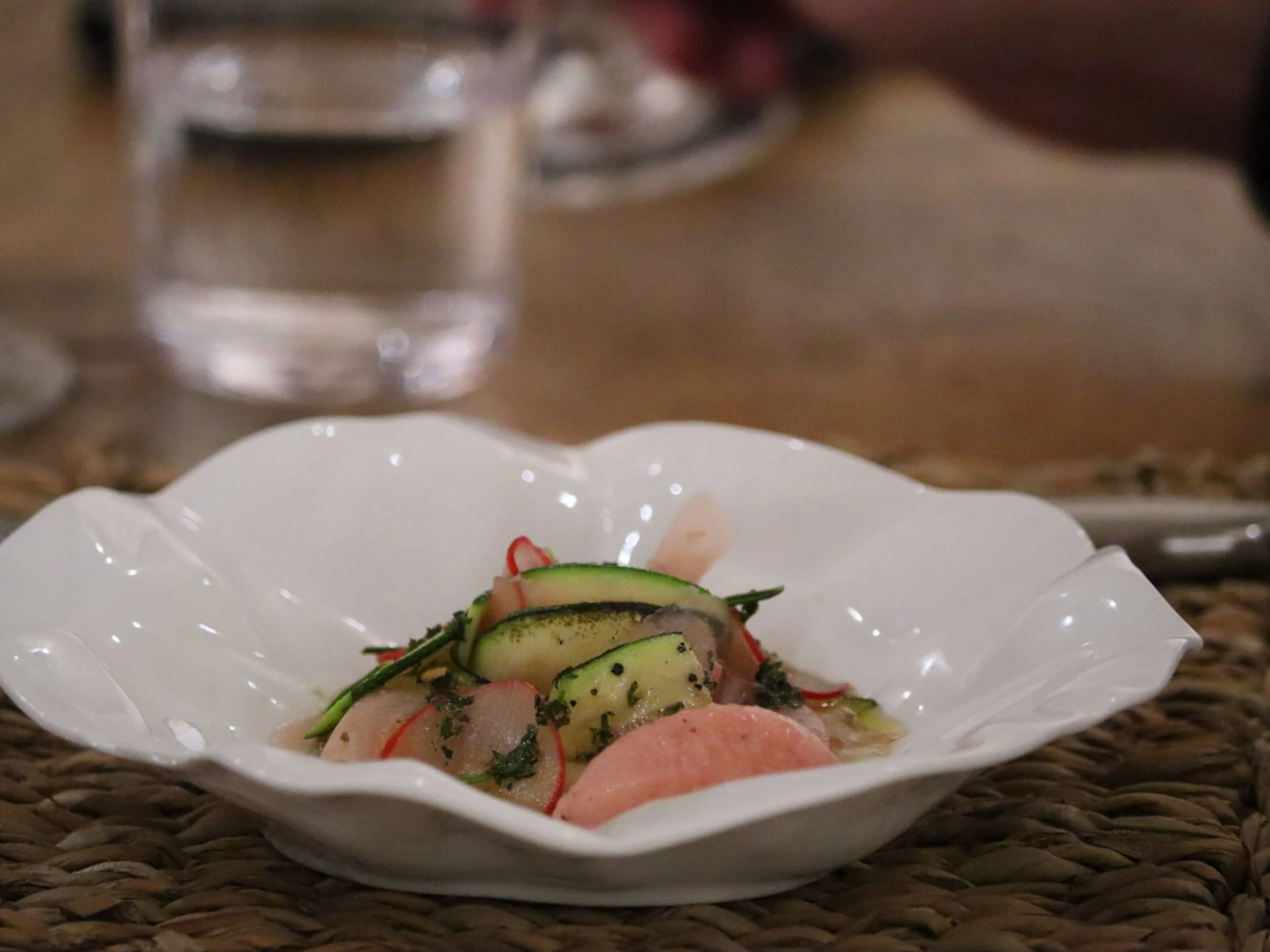 Fine dining vegetable starter with courgette ribbons, radish and delicate herb dressing.

