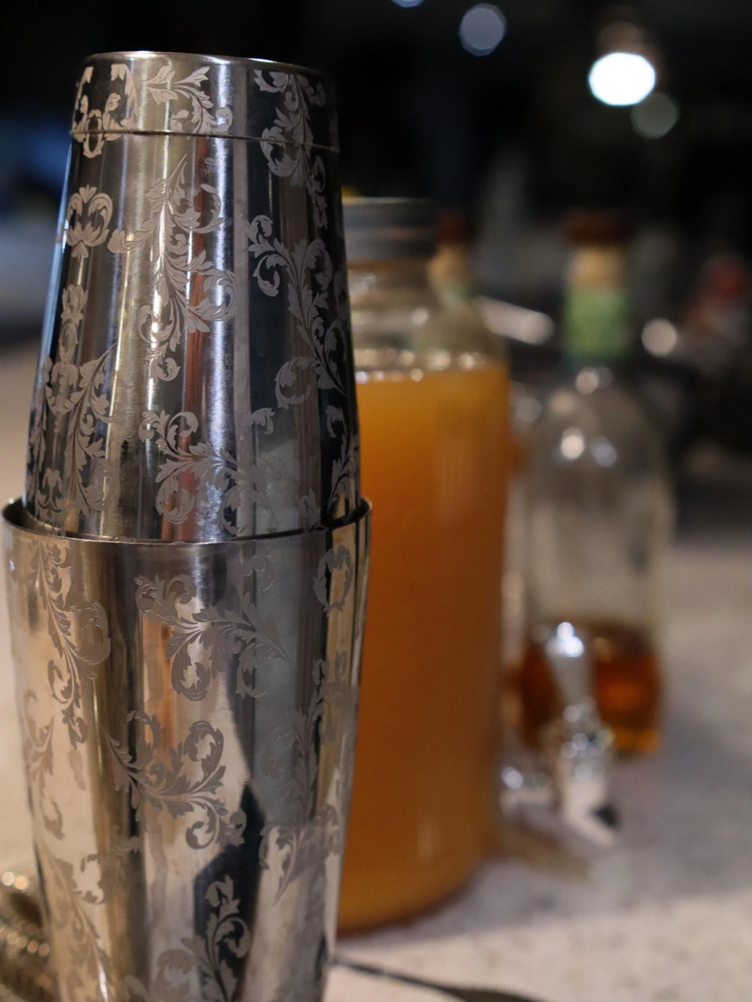 Cocktail shaker and house-made mixers set up for Greek Tings drinks service.
