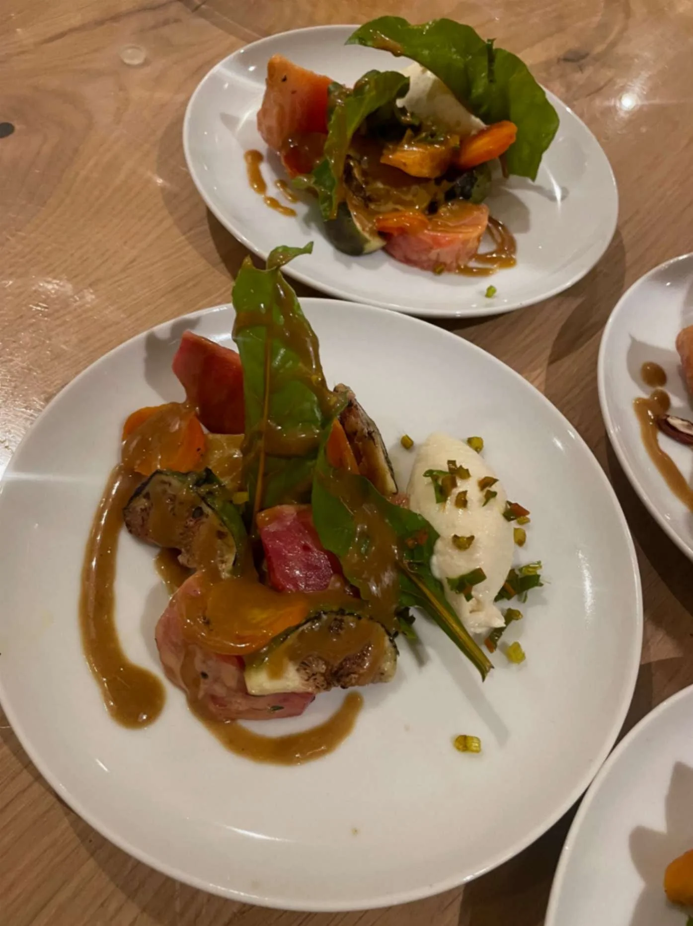 Colourful seasonal vegetable starter with greens, root vegetables, pistachios and creamy 
