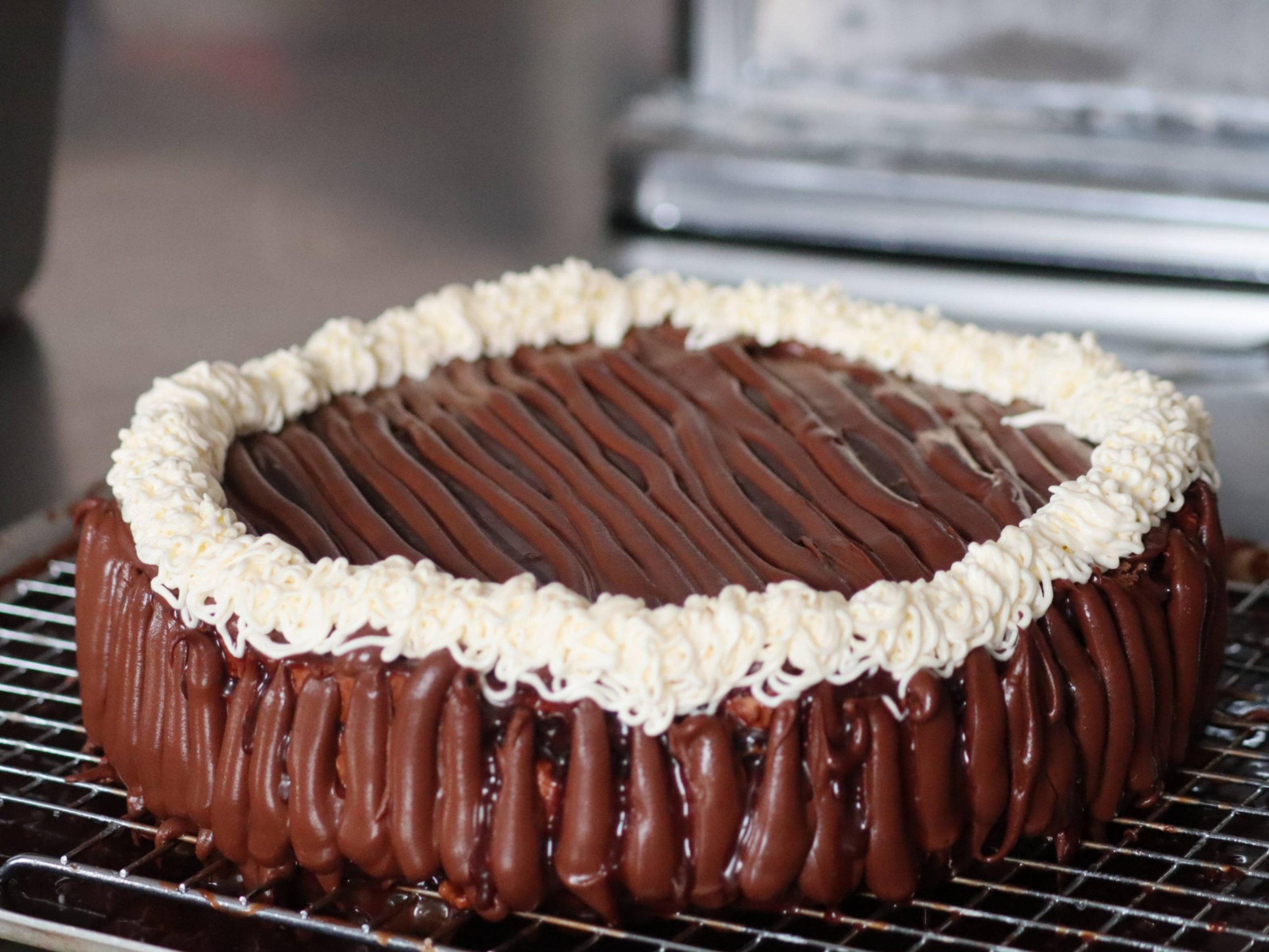 Greek-style sokolatina layered chocolate cake with chocolate glaze, ganache mousse and Chantilly cream.