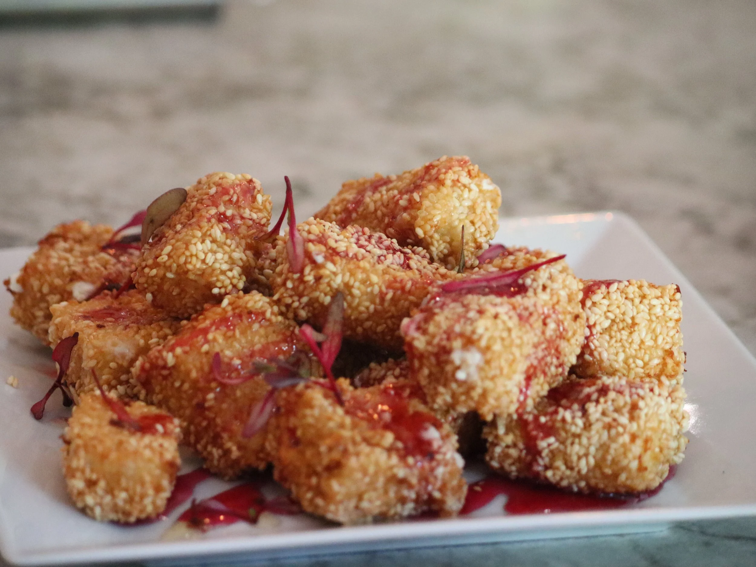 Golden coconut and sesame–crusted feta, finished with Greek honey and raspberry syrup. A perfectly balanced indulgence.