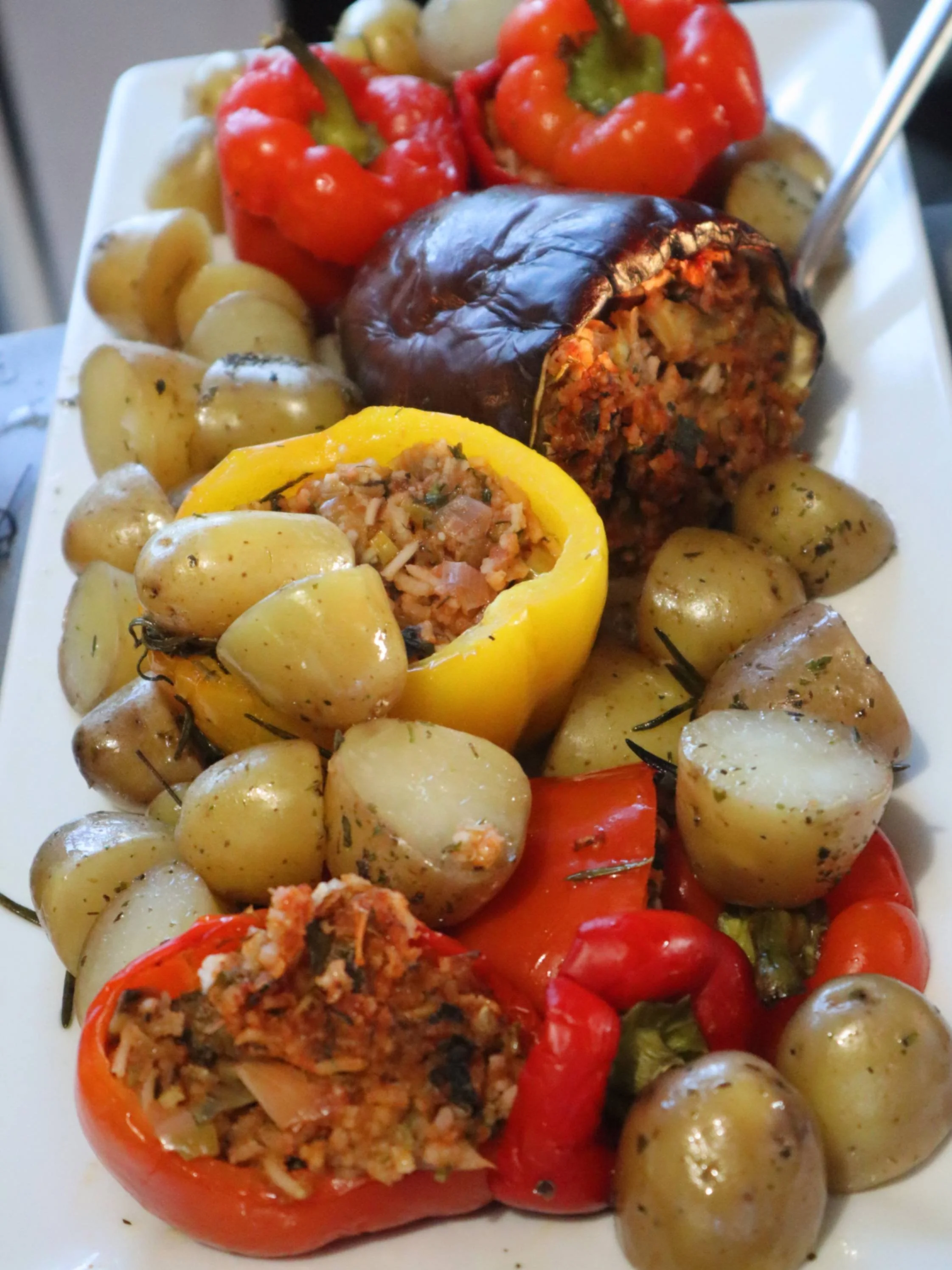 Oven-baked peppers, aubergines and courgettes stuffed with herbed seasoned rice.