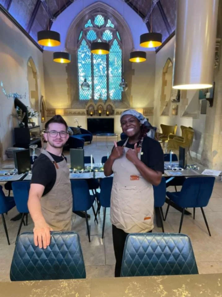 Greek Tings founders smiling in aprons after setting up a private event.
