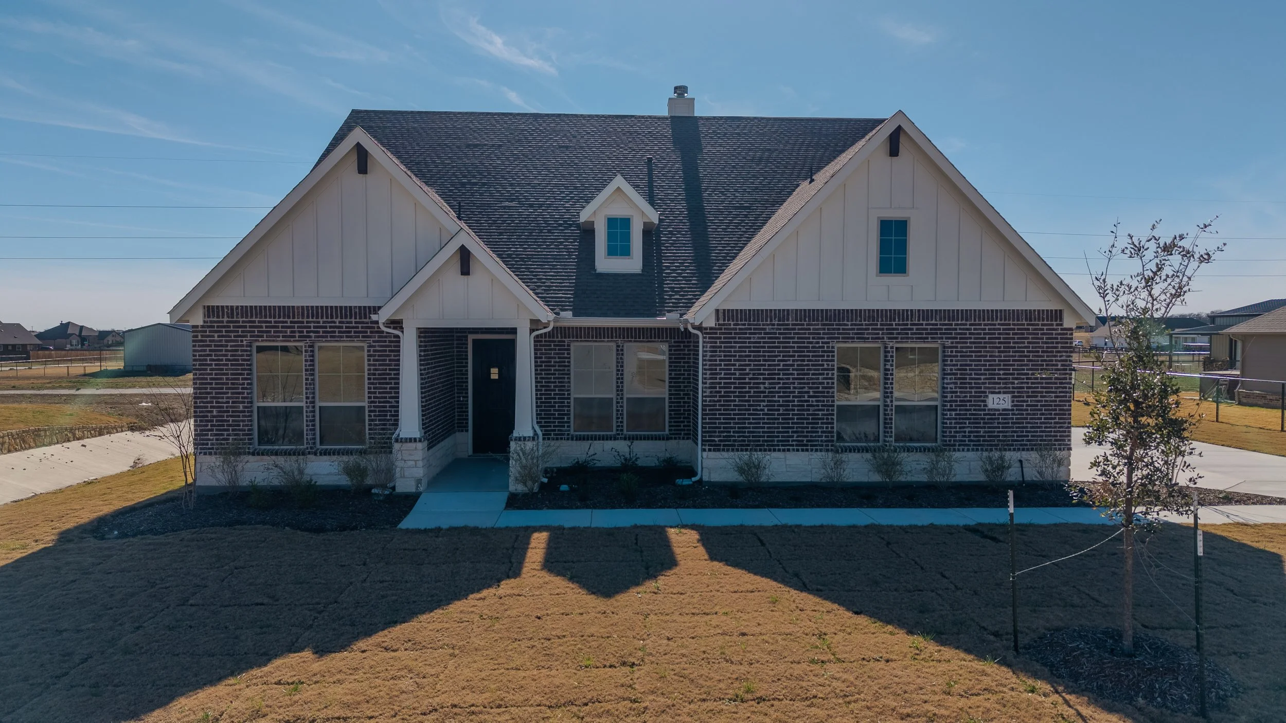 “HDR real estate exterior photography in the DFW area highlighting a residential home with vibrant colors, clear skies, and enhanced detail.”
