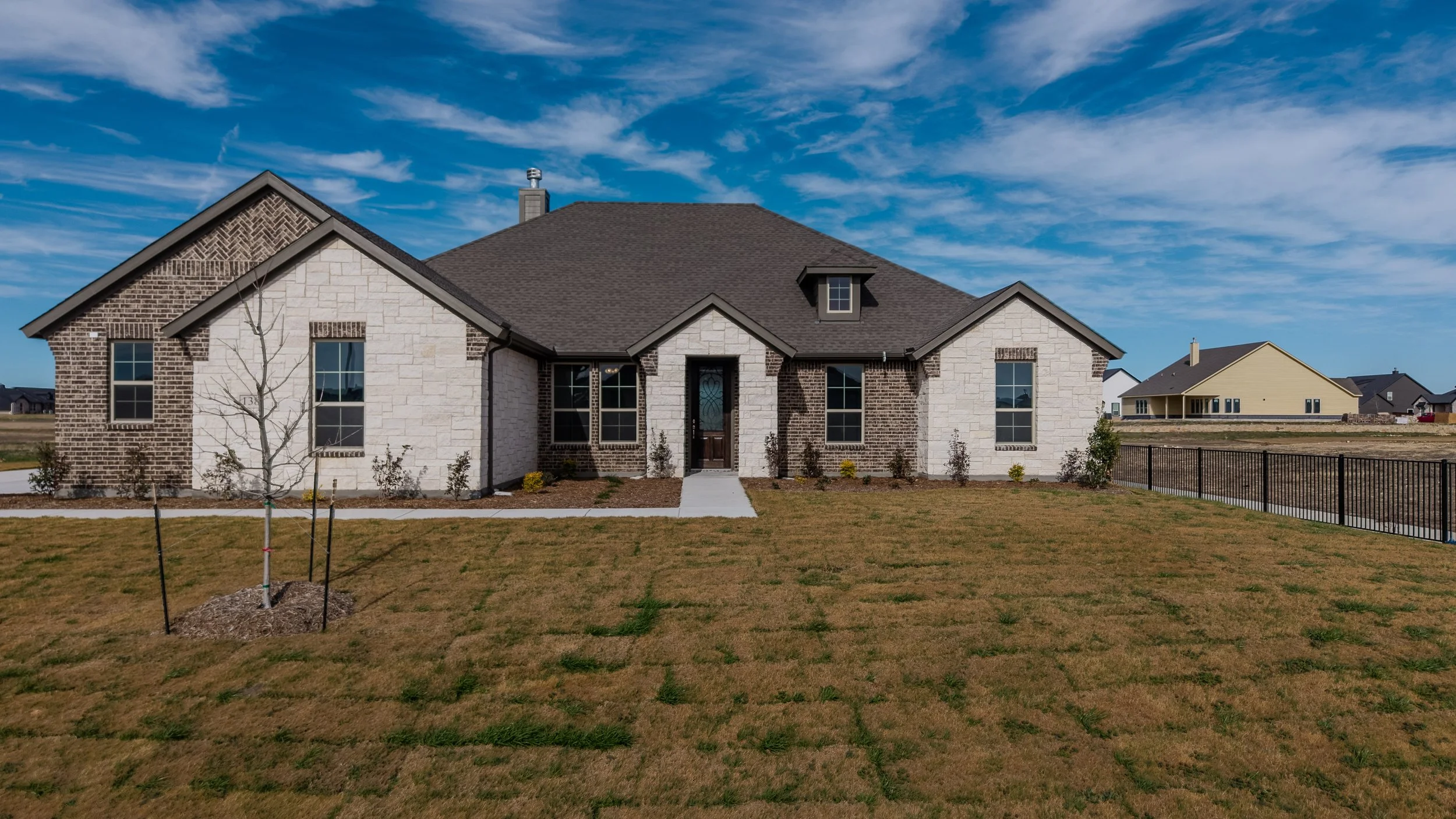 “HDR real estate exterior photography in the DFW area highlighting a residential home with vibrant colors, clear skies, and enhanced detail.”