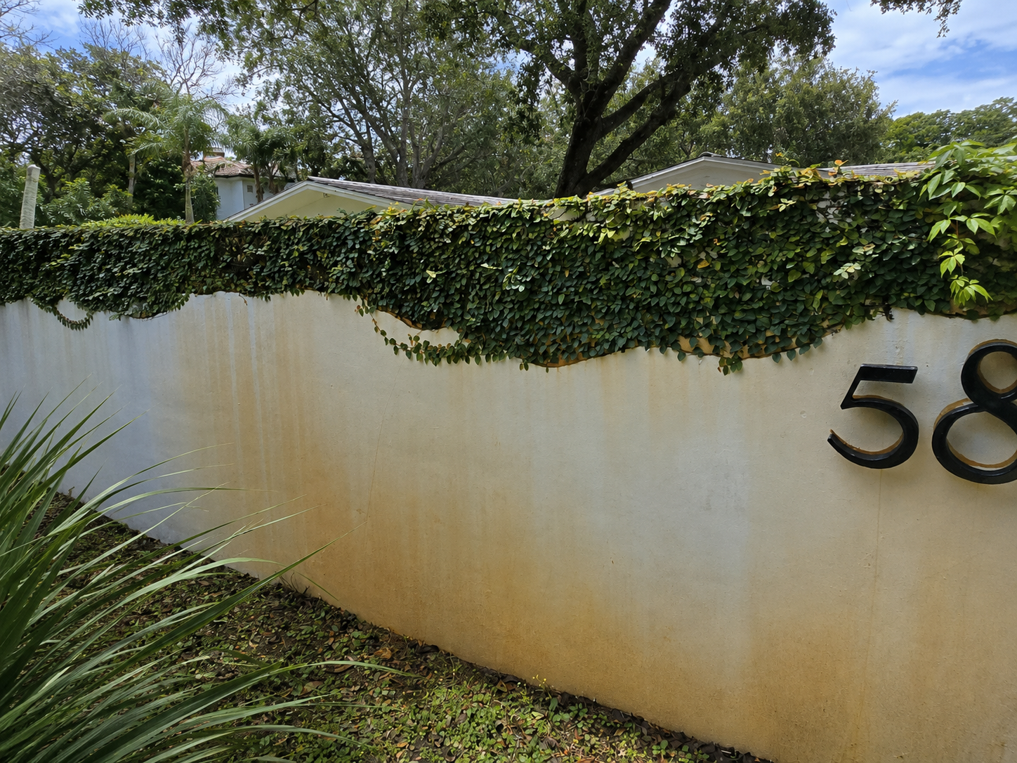 Stained exterior wall before house washing in Miami