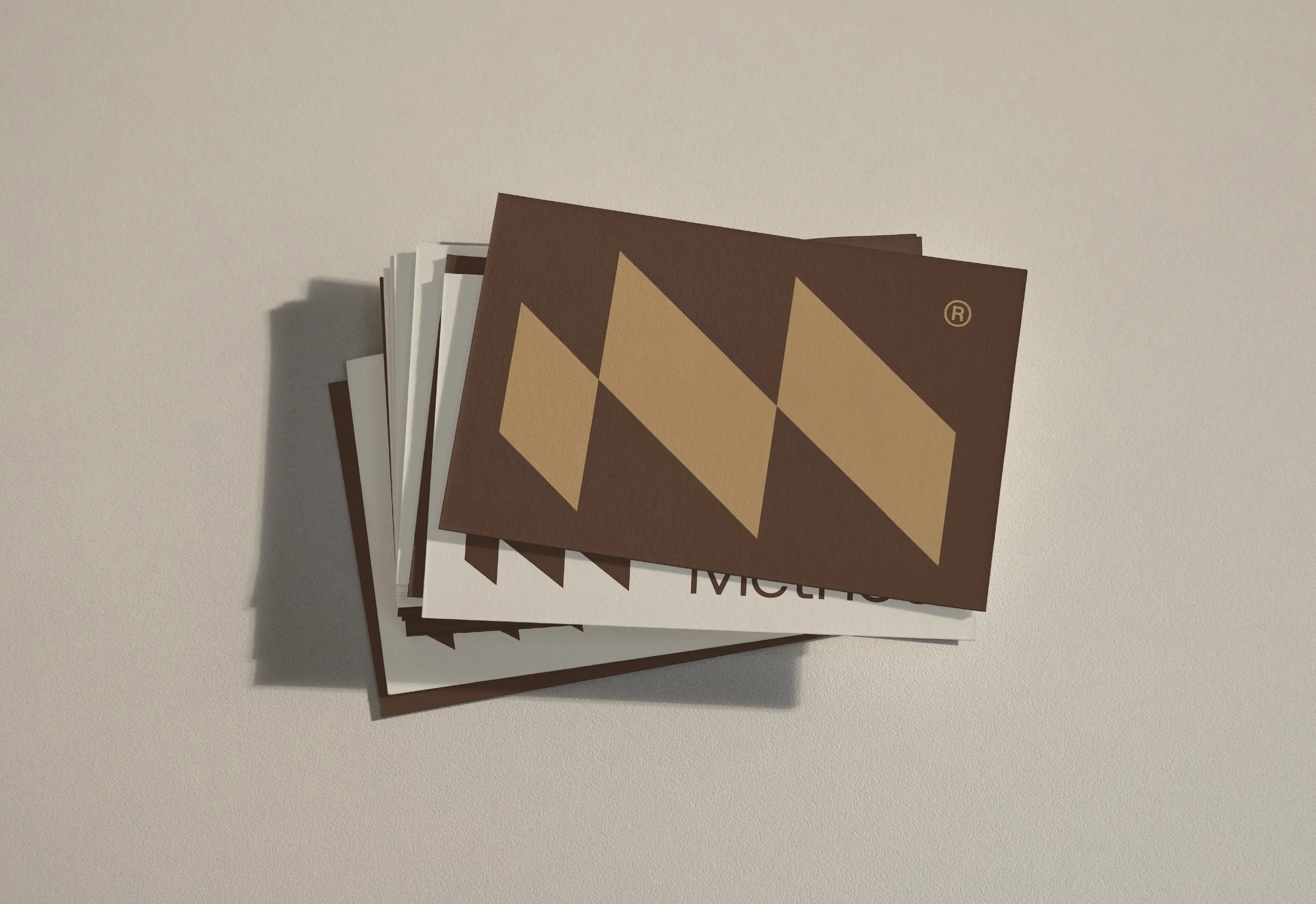 A stack of bookmarks with a chessboard pattern on the top bookmark, placed on a white surface.