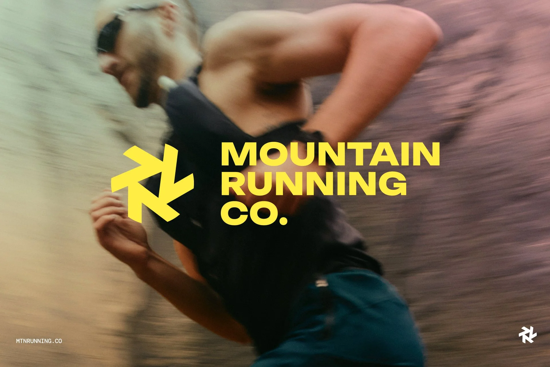 A man with a beard running outdoors with a blurred background of trees and sky, wearing headphones, a black shirt, and dark shorts, with a yellow logo and text overlay reading 'Mountain Running Co.'