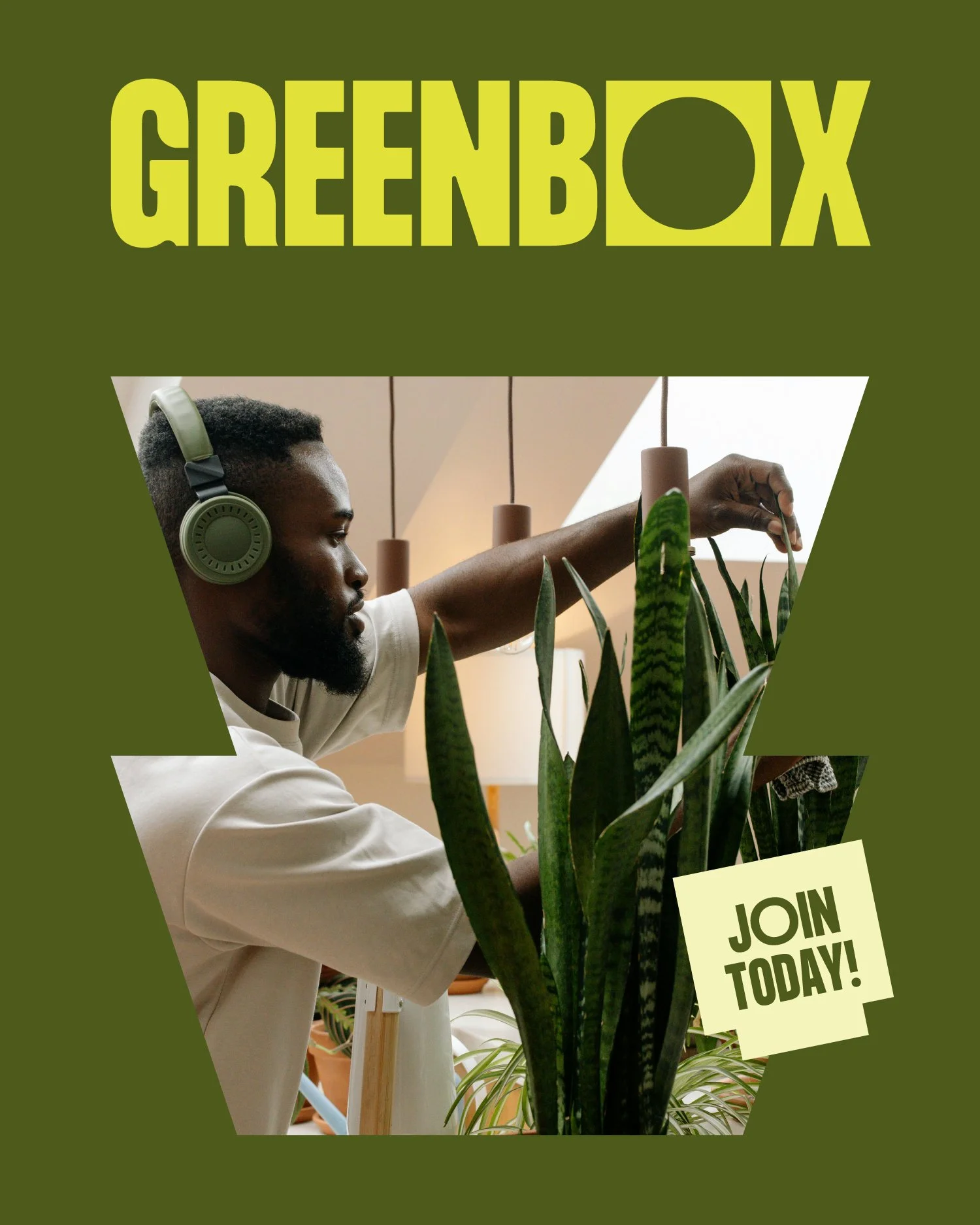 A man standing among indoor plants, wearing headphones, with a green poster in the background promoting Greenbox and inviting viewers to join today.