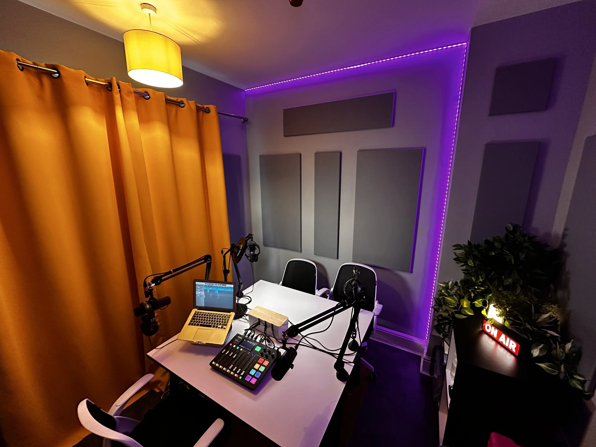 The Crane Nest Cambridge podcast studio with microphones, mixer and an on-air sign