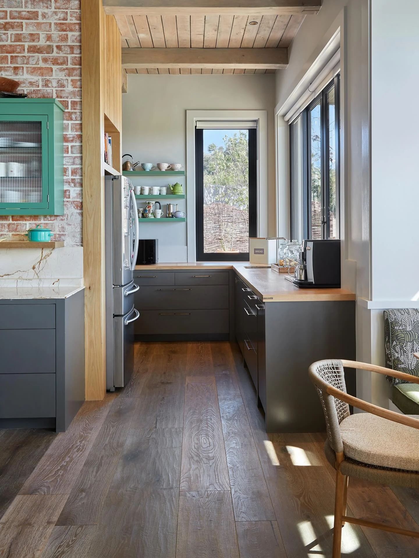 A serene kitchen filled with natural wood tones and sweeping hill views. Quiet luxury that invites you to unwind and lift the spirit.