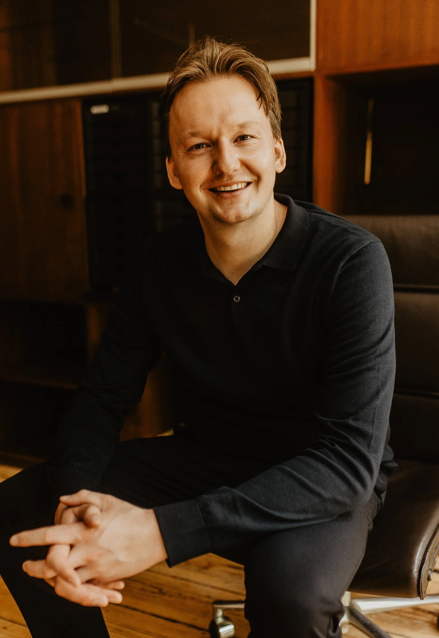 Cees Weerd op het kantoor van Afschied door Anne: Rusthoflaan 80 Rotterdam, op een leren bureaustoel.