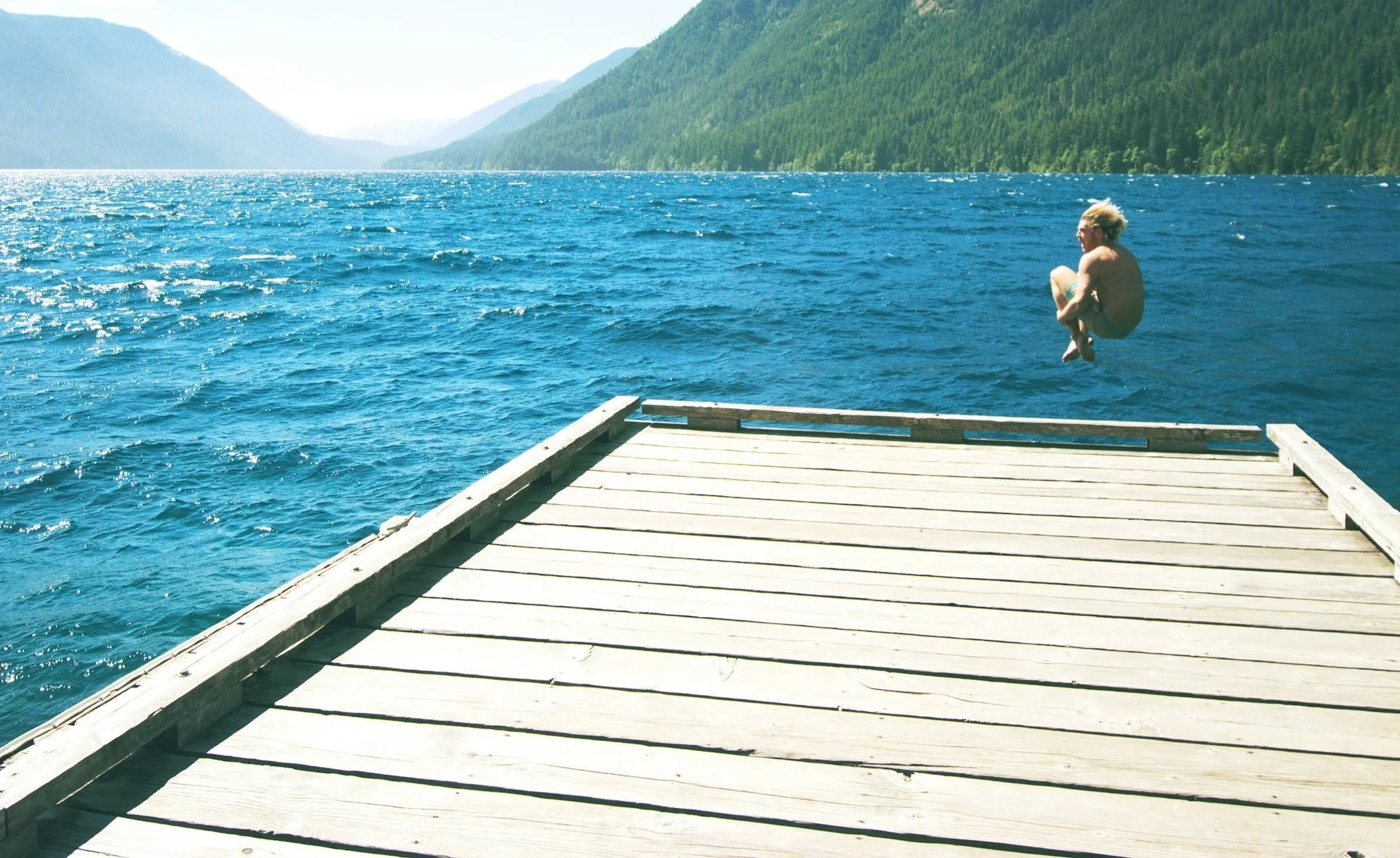 Restored wooden dock on a lake,  Sandpoint, Idaho, by Deck Restoration.