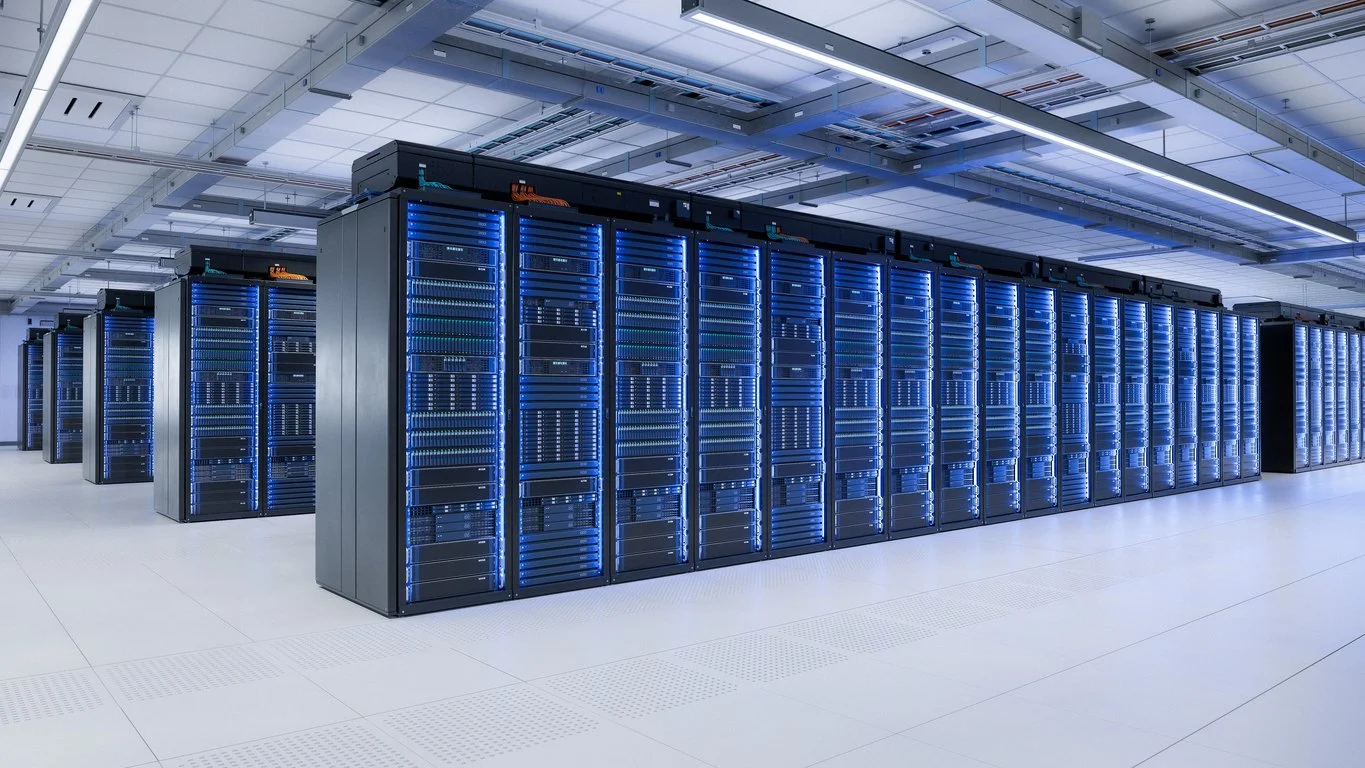 Row of server racks in a modern data center with blue LED lights.