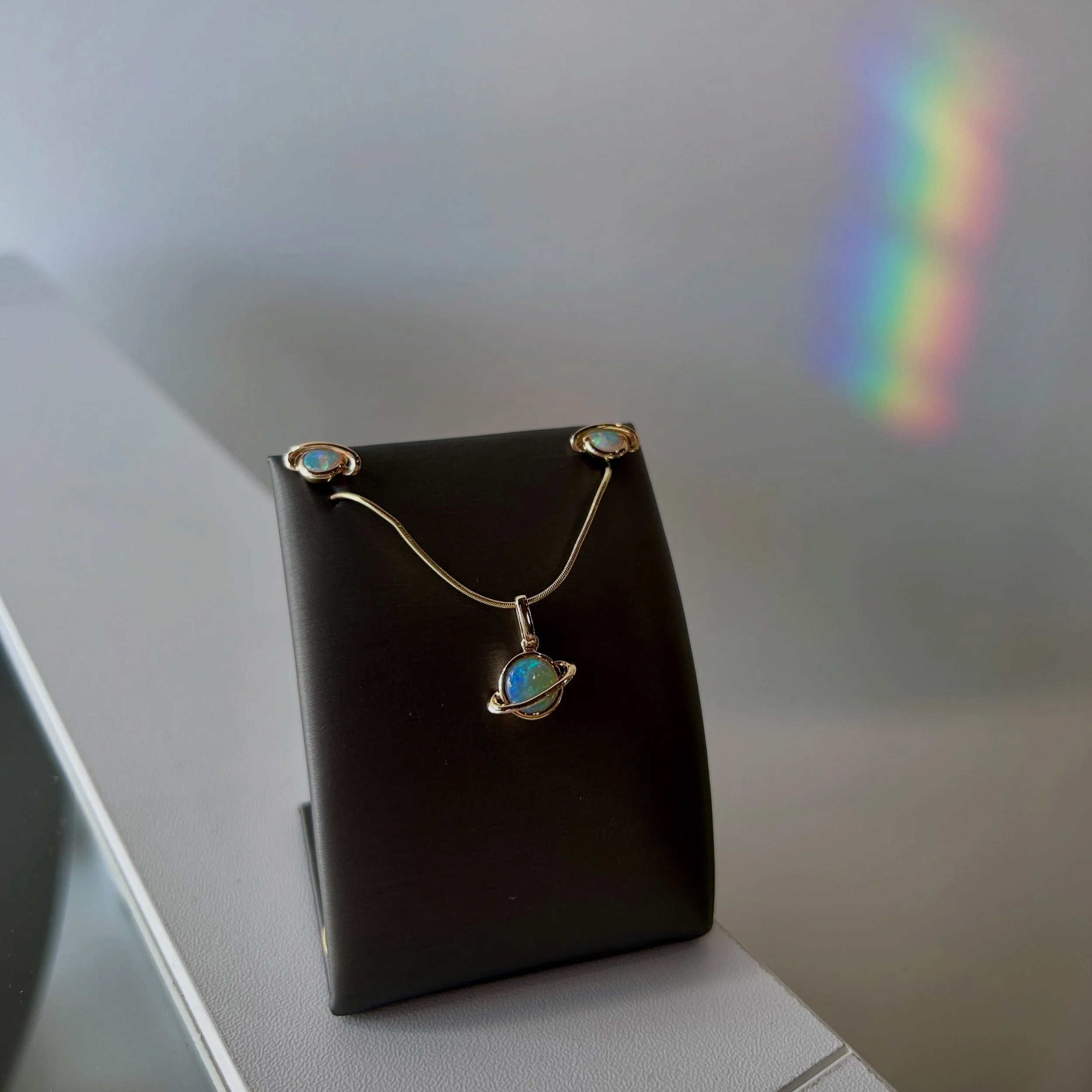 ✨💫🪐🌎We got a NEW earring &amp; pendant set in that is out of this world 💫🪐🌎✨

&bull; 14K Gold✨
&bull; Bezel Set 💫
&bull; Round Cabochon Cut Australian Opals🩵
&bull; Saturn Design🪐

#octoberbirthstone #saturndesign #newjewelry #jamiestdm #vir