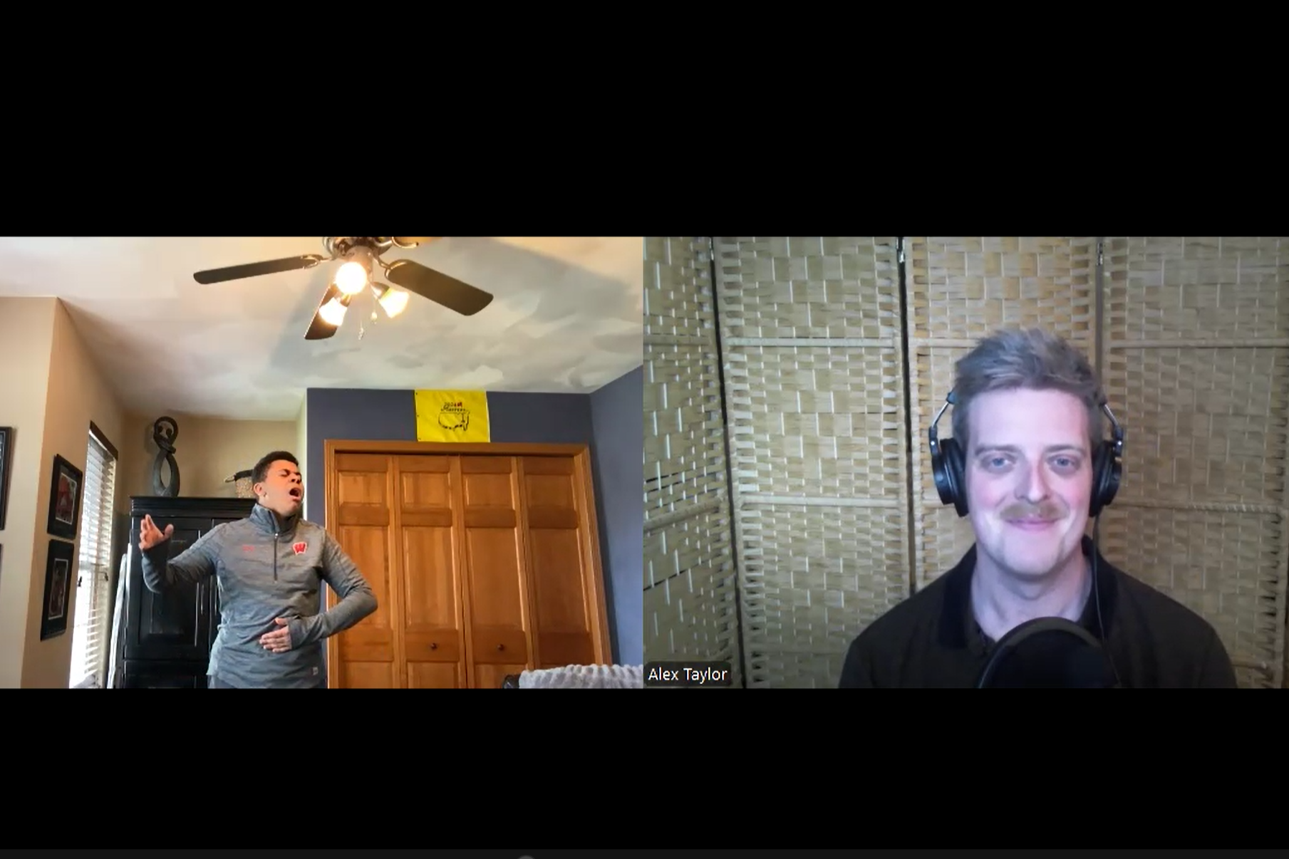 Two men, one singing passionately with one hand on his stomach, the other smiling with headphones on, in a split-screen video call. The singing man is in a room with a ceiling fan, a wooden closet, and windows. The smiling man is in front of a woven room divider.
