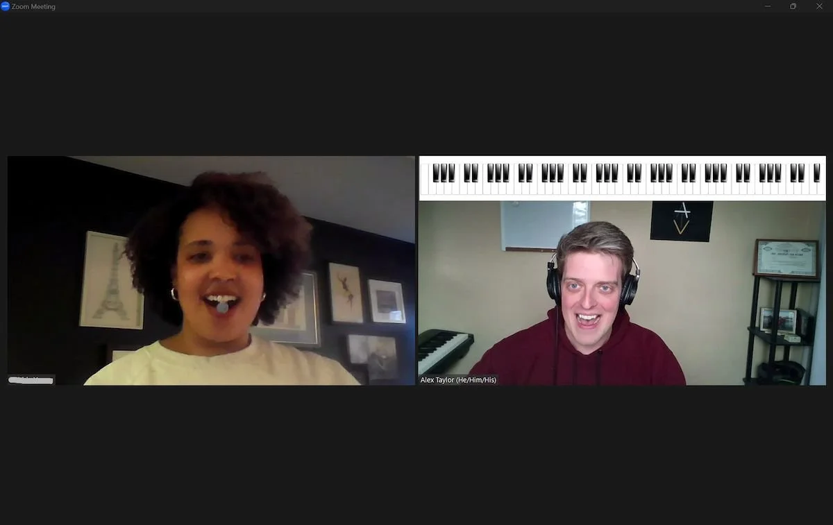 Two people in a Zoom call, a woman on the left with curly hair smiling and a man on the right with headphones, smiling, with a virtual keyboard and music note graphic on the top of his video window.