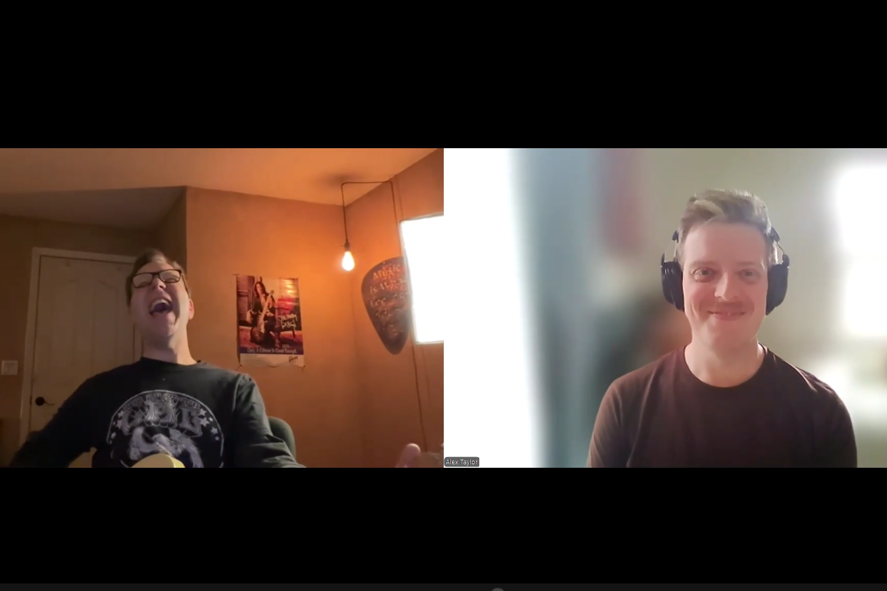 Two men participating in a video call. The man on the left is wearing glasses and a black shirt, laughing with an open mouth, sitting in a room with warm lighting, a poster, a guitar, and a hanging light bulb. The man on the right has light brown hair, is wearing large headphones, and has a smile, with a bright background.