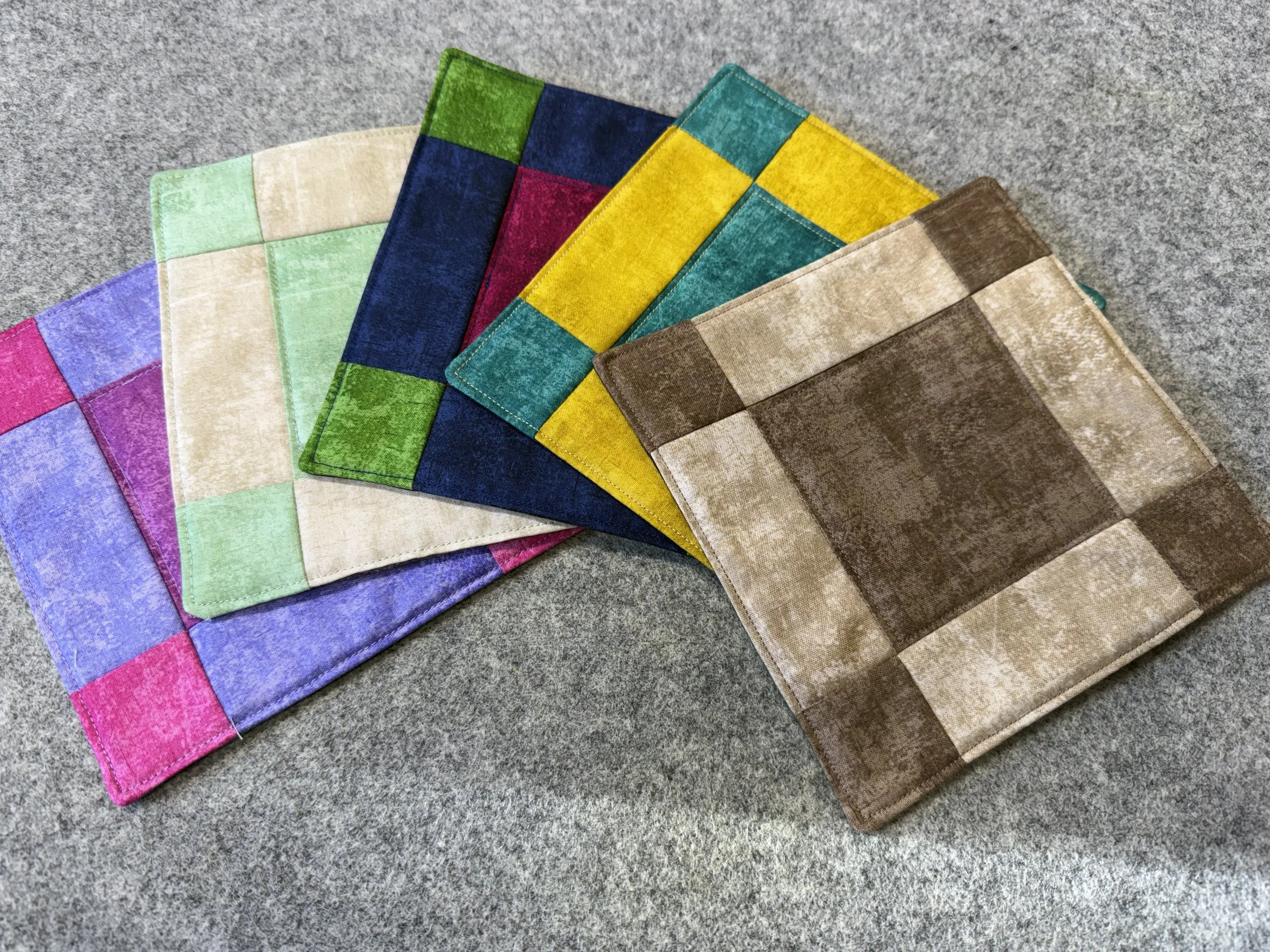 5 assorted 9-patch hot pads in a variety of colour themes.