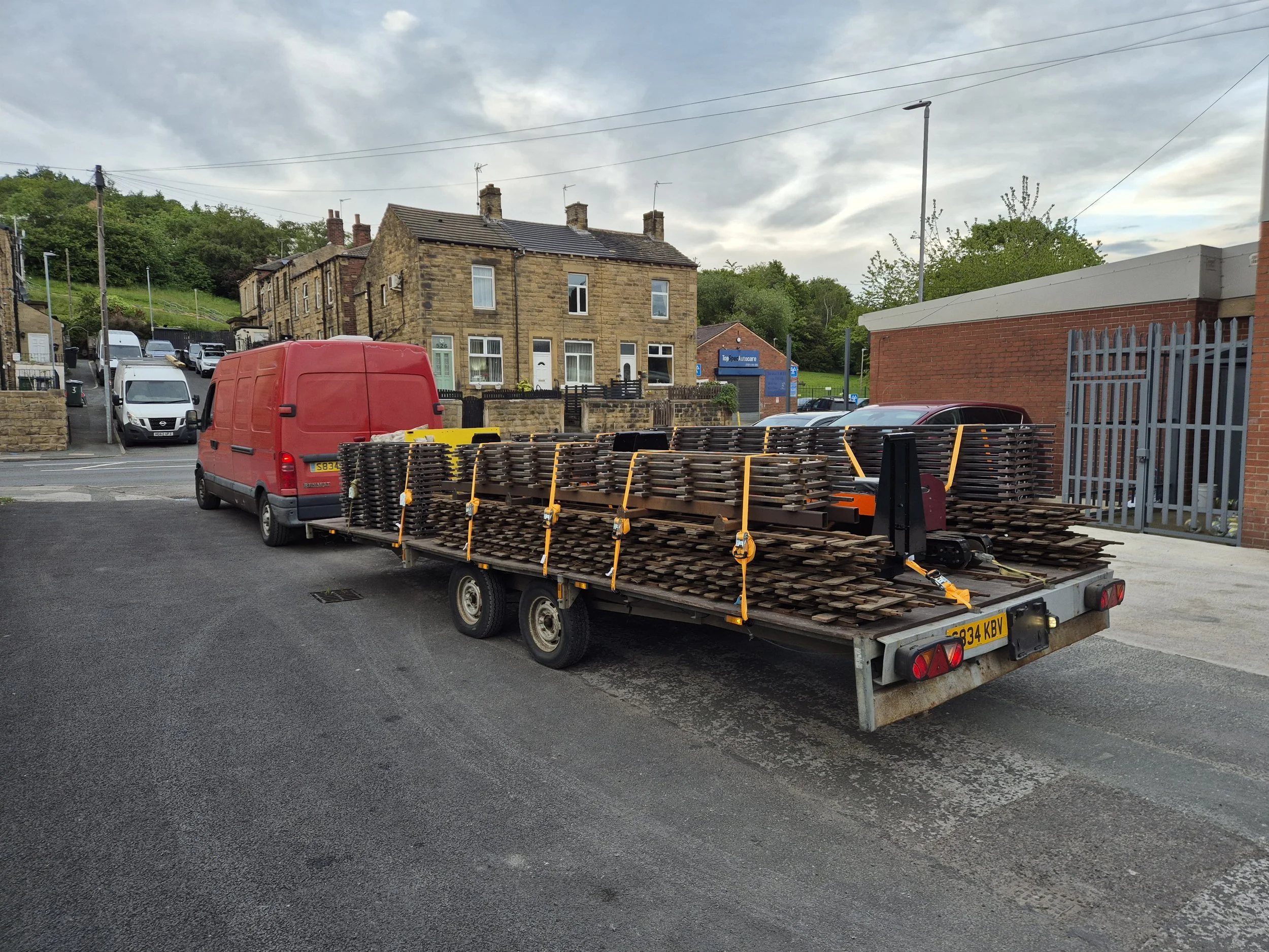 Vintage steam locomotive and carriages, loaded on a dual axle trailer pictured on a bitumen road, with a wooden fence behind, able to travel anywhere in the UK including the Midlands, Wales, North England, Lancashire, Yorkshire and Lincolnshire