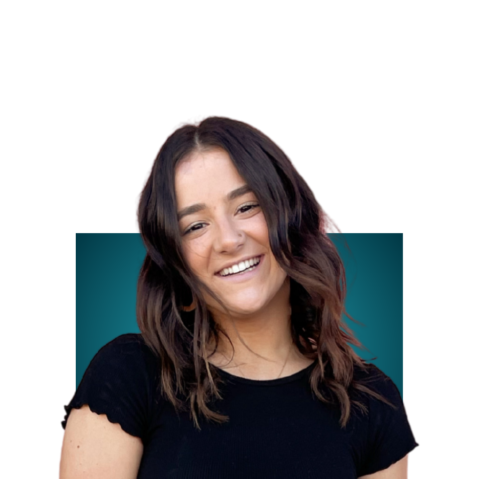 Shannon Steeves. Smiling woman with shoulder-length hair and glasses, wearing a navy blue embroidered top, against a teal background.