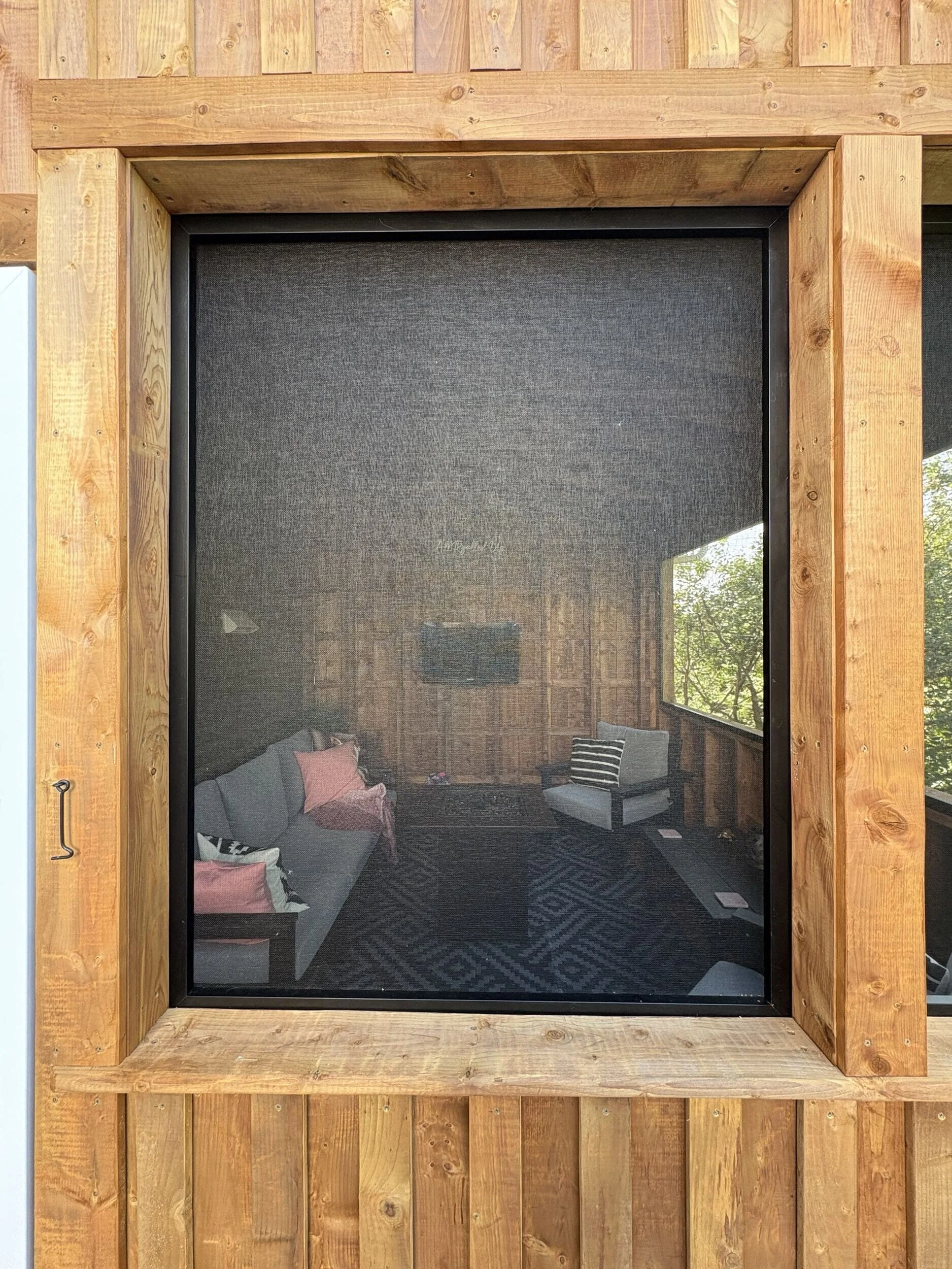 Custom screens with removable winter panel system inside The Treehouse screened deck addition, allowing the outdoor living space to be used year-round in Halifax, Nova Scotia.