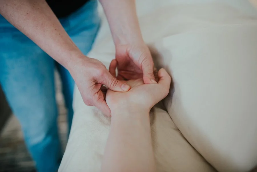 Kody Gabriel performing hand massage during rest and revive massage therapy session