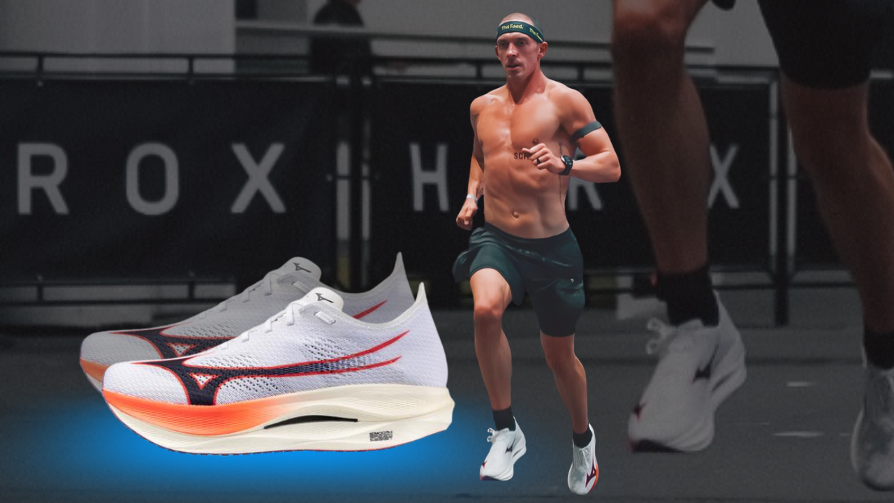 A male runner is running in a race, shirtless, wearing black shorts, white running shoes, a headband, and a watch. Two pairs of white and orange running shoes are digitally added to the foreground.