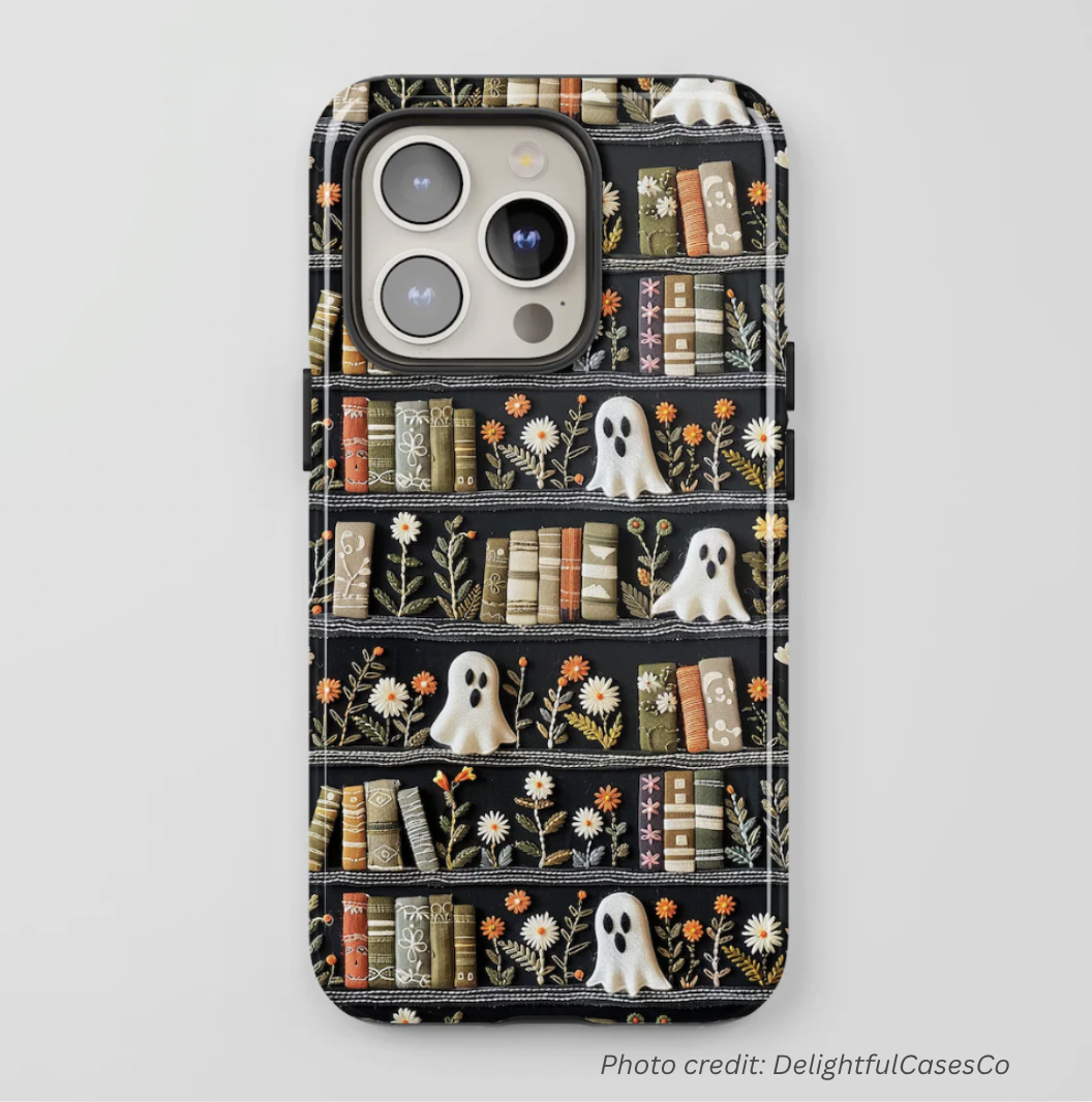 Phone case of ghosts on a bookshelf done using an embroidery look