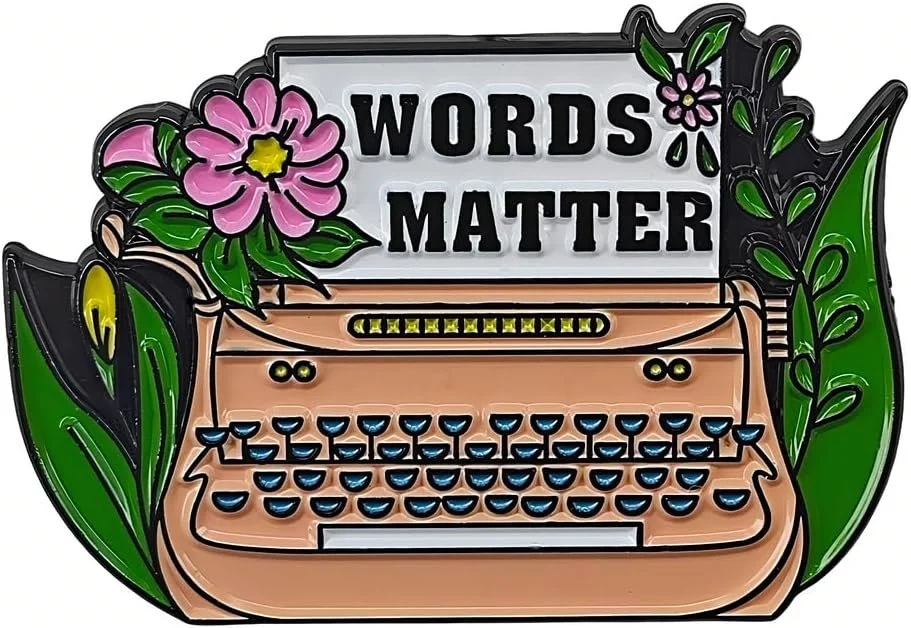 Pin of a typewriter. On the sheet of paper is written: Words matter