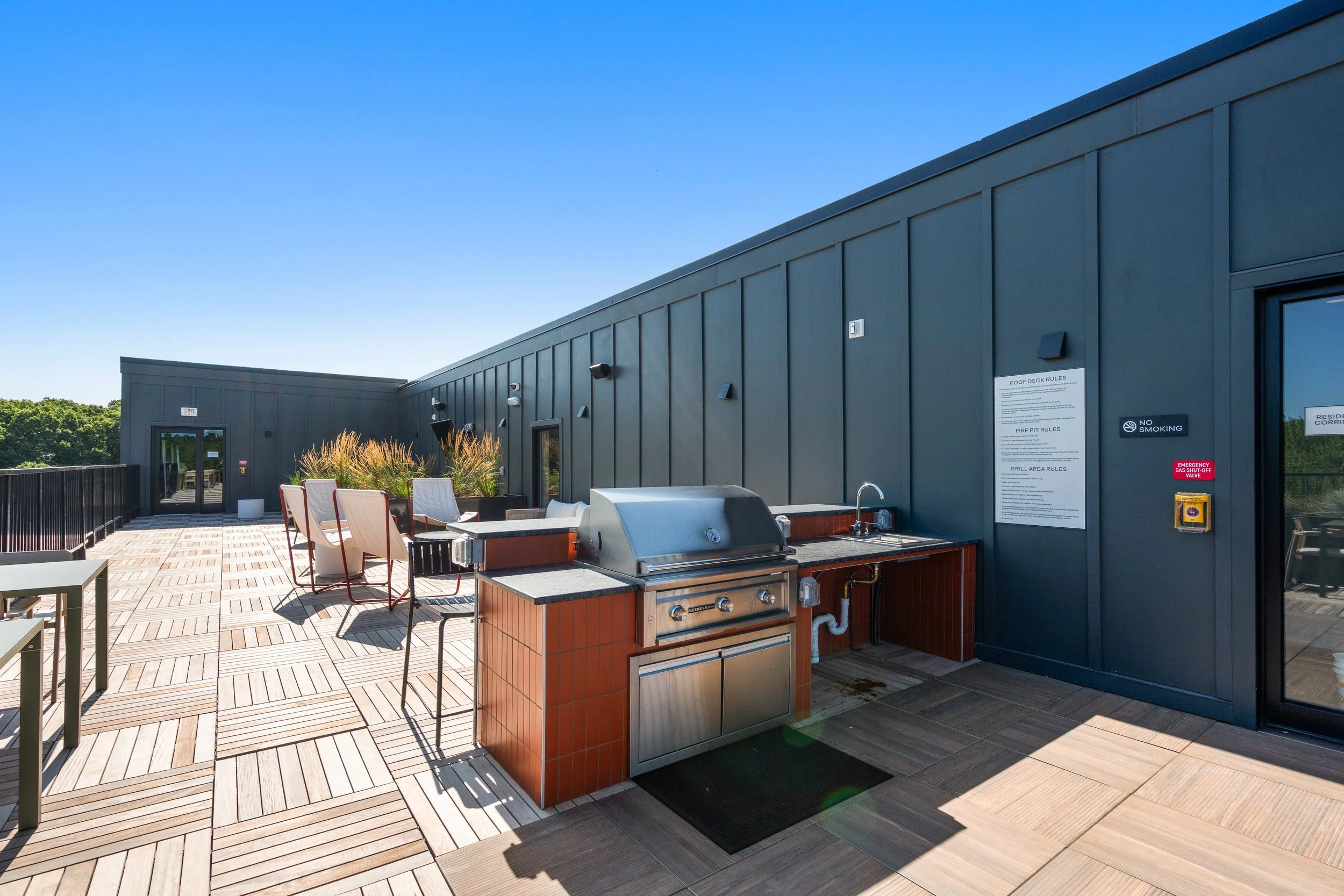 Vibrant Rooftop Deck with an outdoor kitchen and stunning views of Stoneham at The Devon at Weiss Farm
