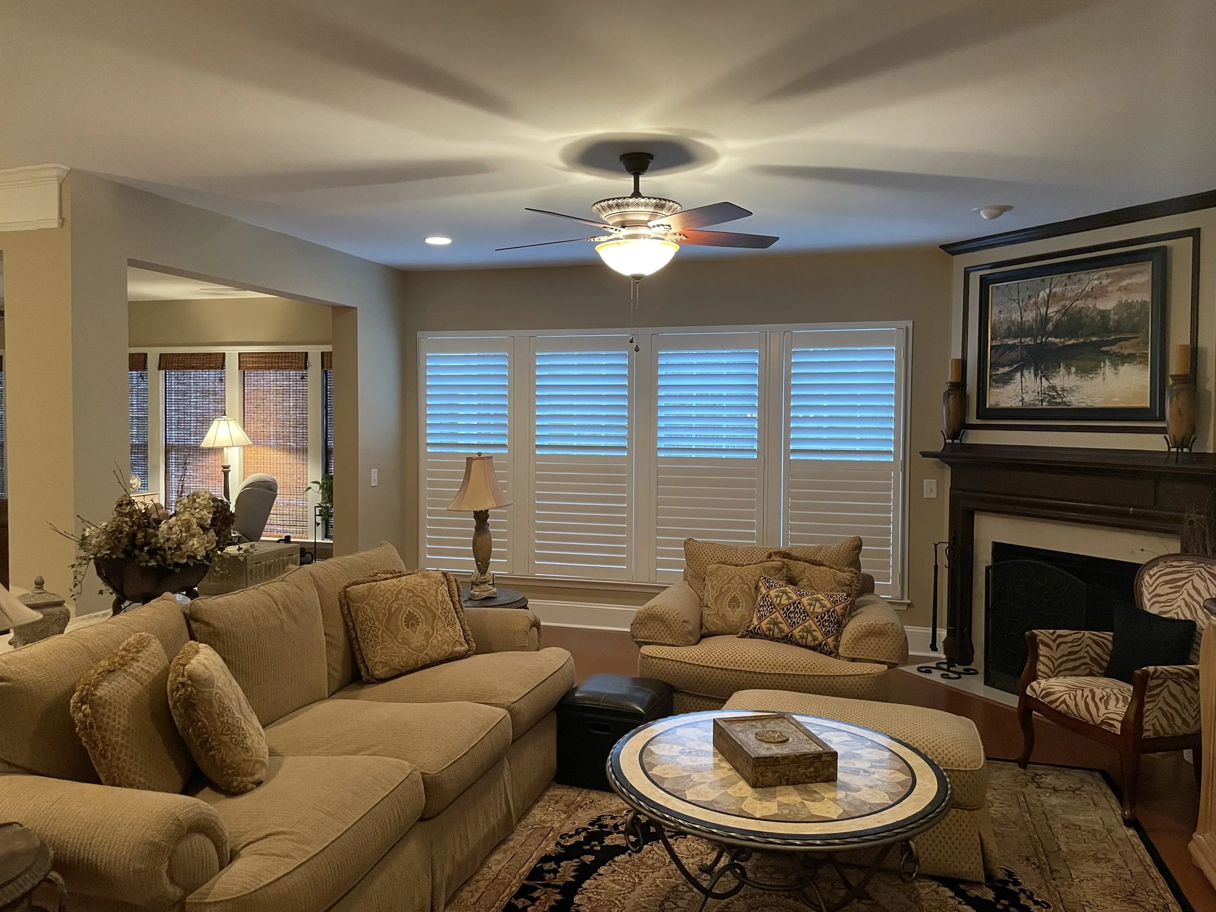 Living Room split tilt shutters pared with Woven Woods