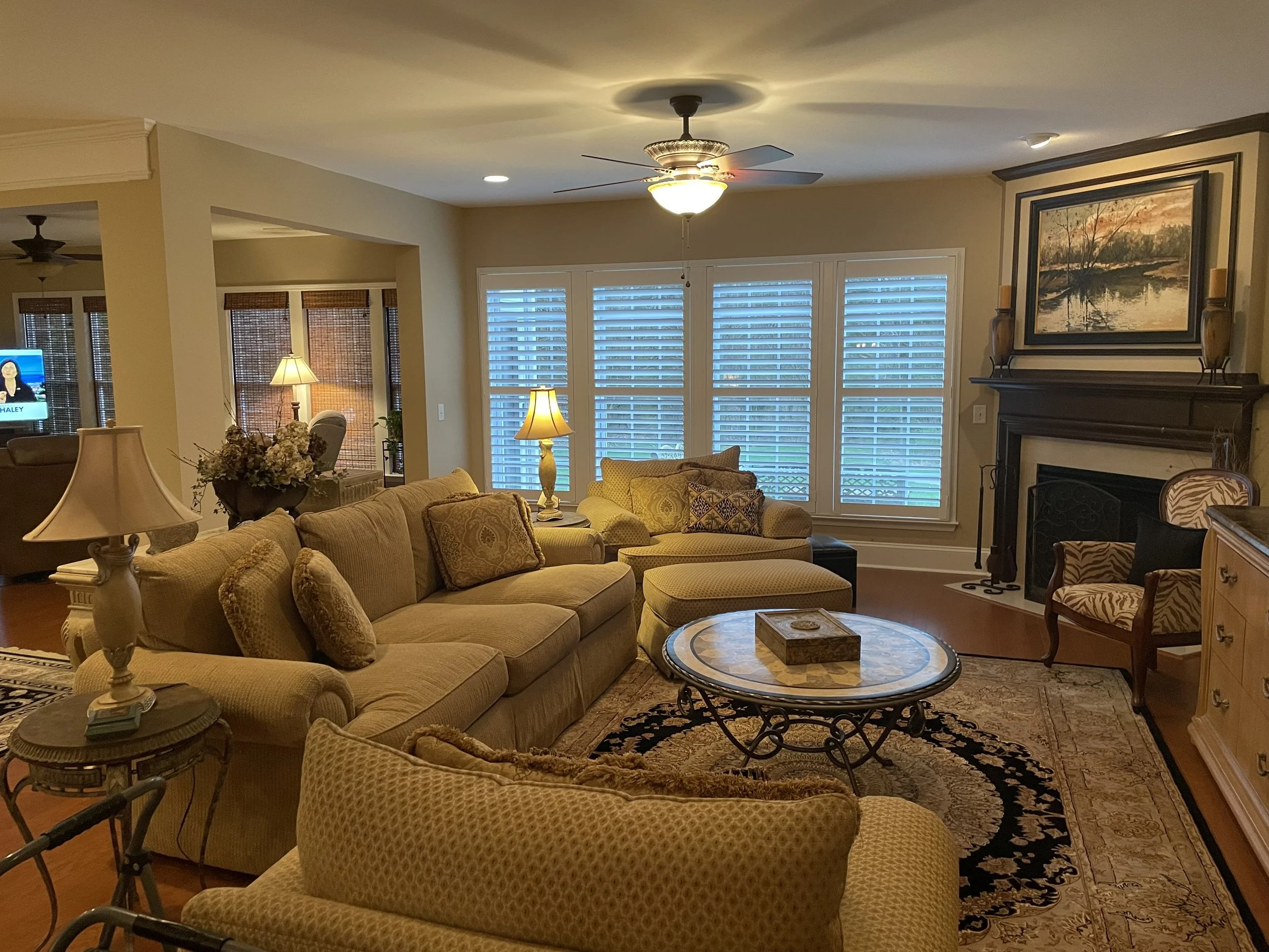 Living room divider rail shutters with roman shades