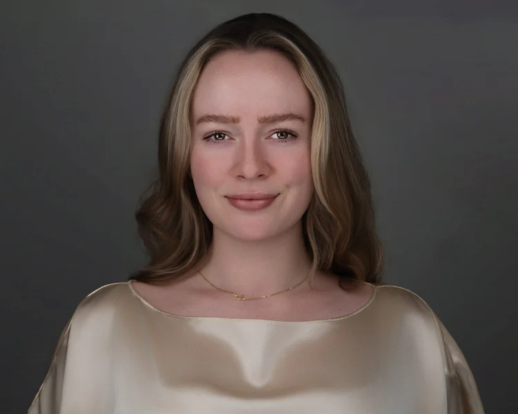 Professional headshot of a woman in a champagne silk top on a gray backdrop, photographed by Steven B Studios in Lafayette, CA