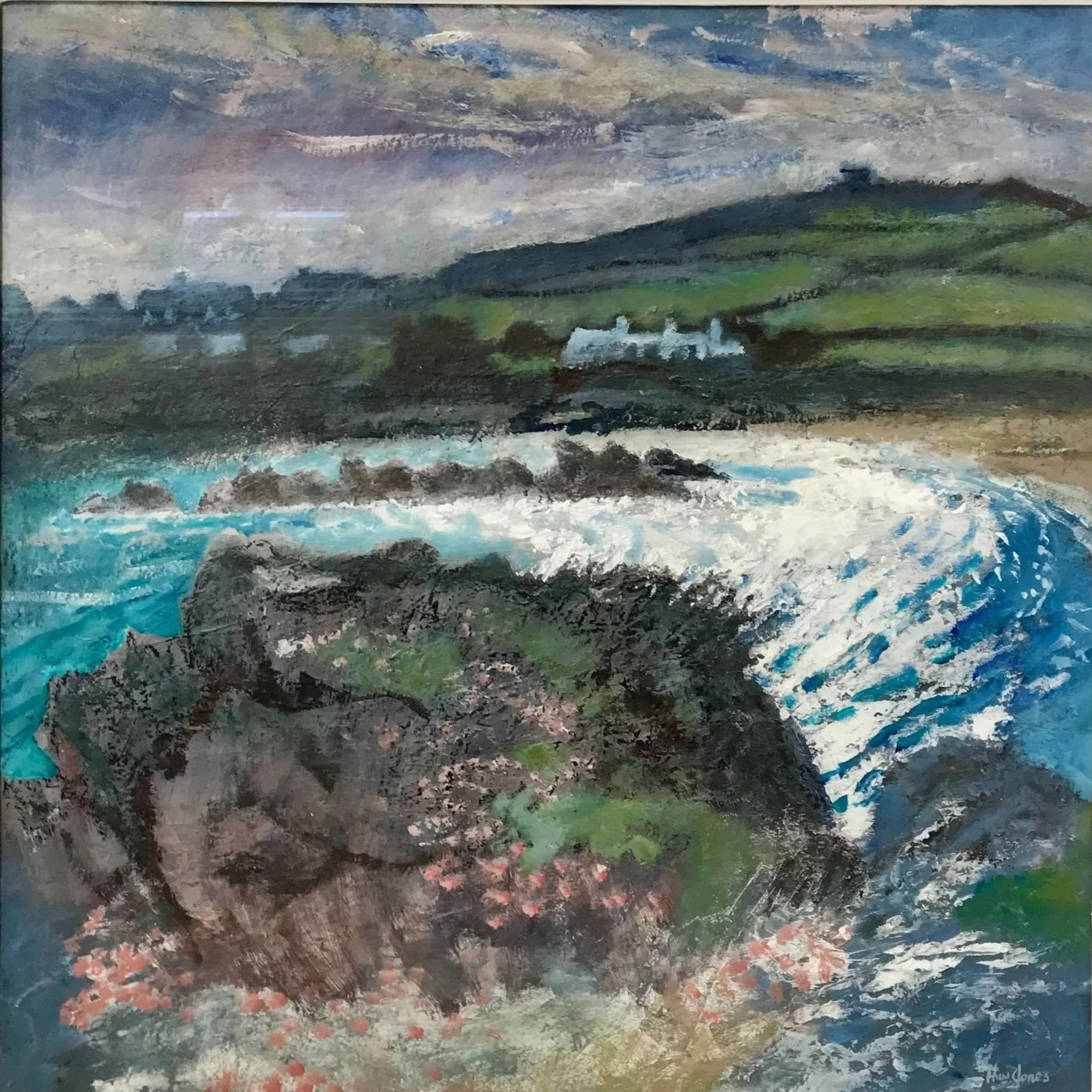 Landscape painting of a coastal scene with waves crashing against rocks, green hills, and distant cottages under a cloudy sky.