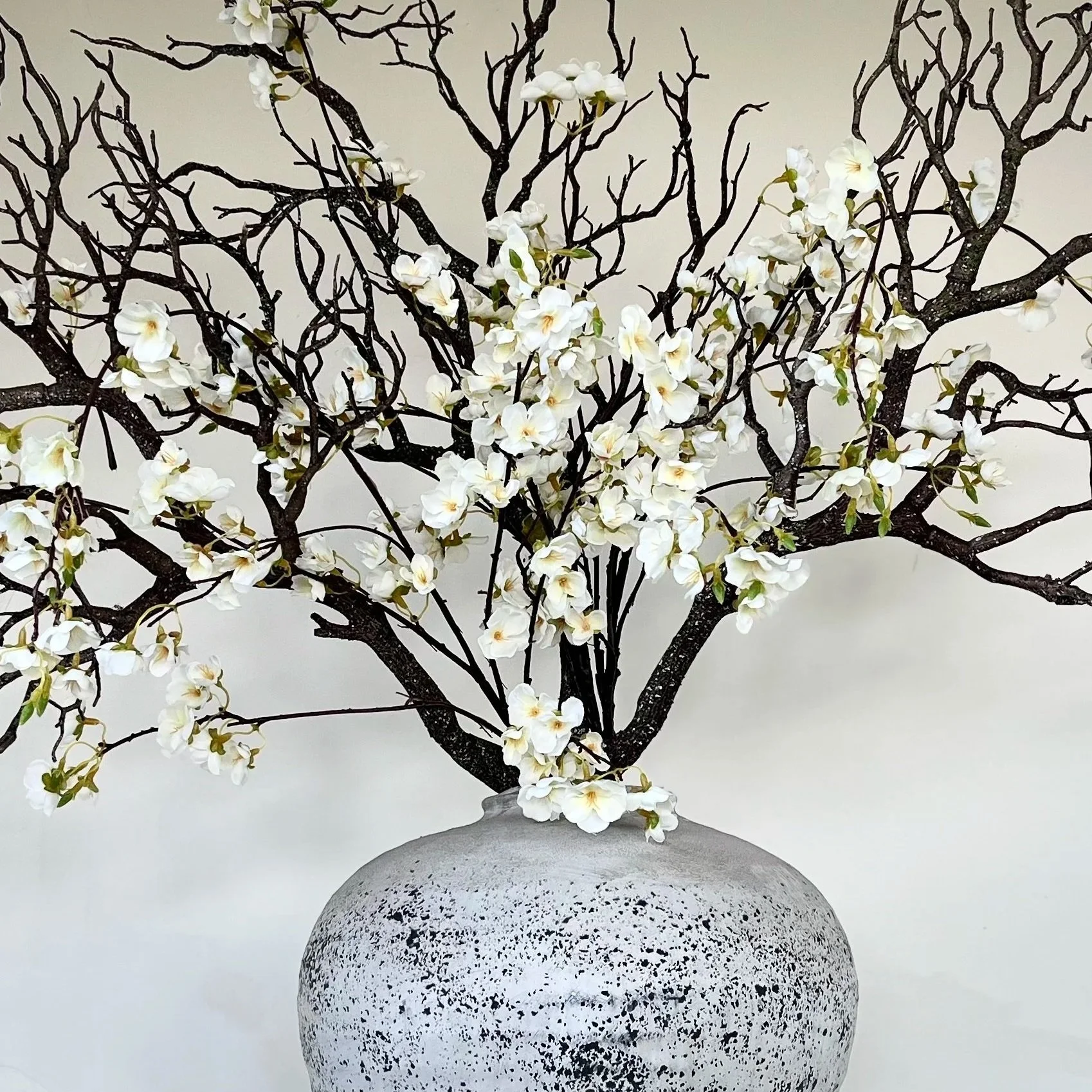 The Japanese Blossom and Brand Bouquet has delicate white flowers as a beautiful backdrop.