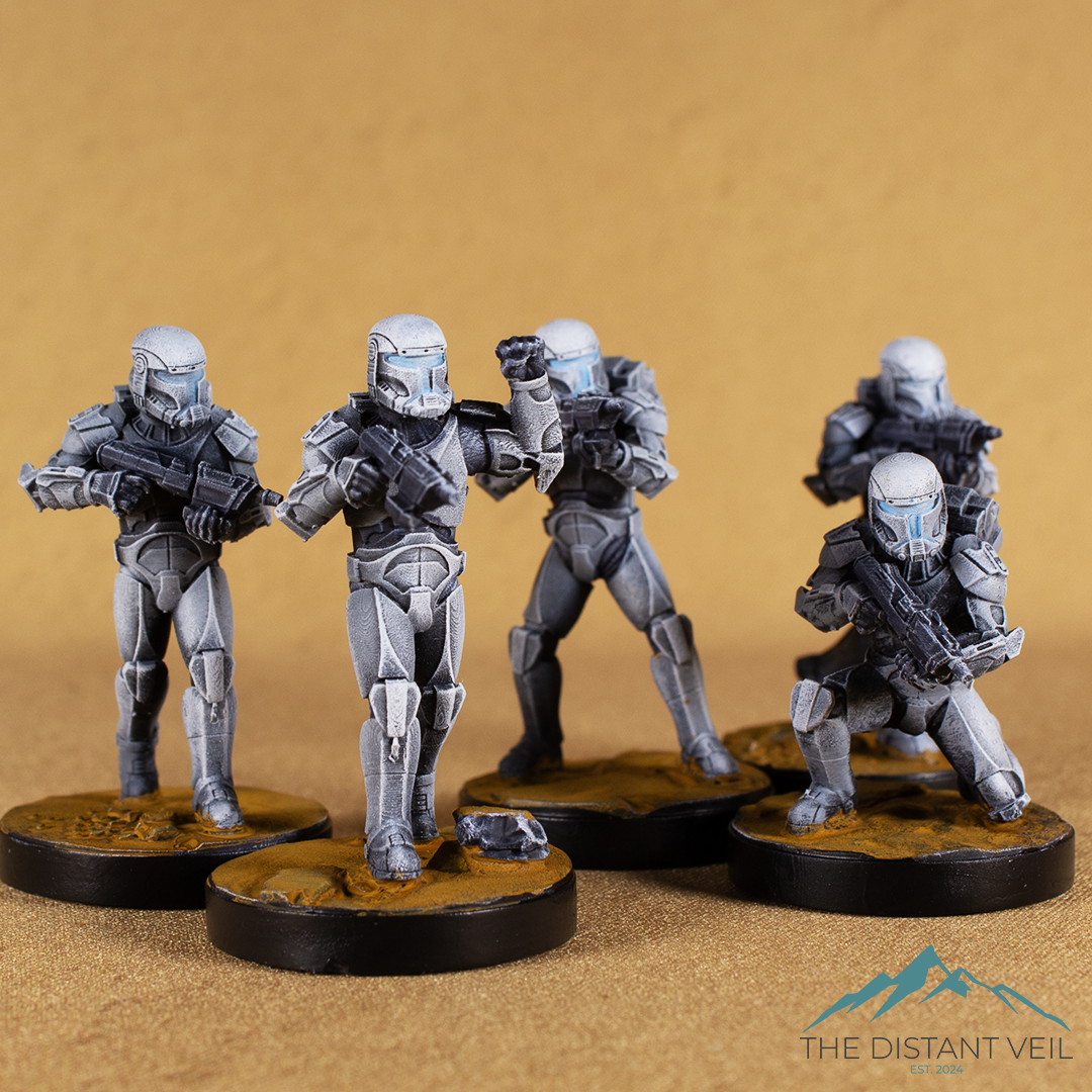 Five miniature soldiers in futuristic armor and helmets, holding guns, positioned on round bases with a plain brown background.
