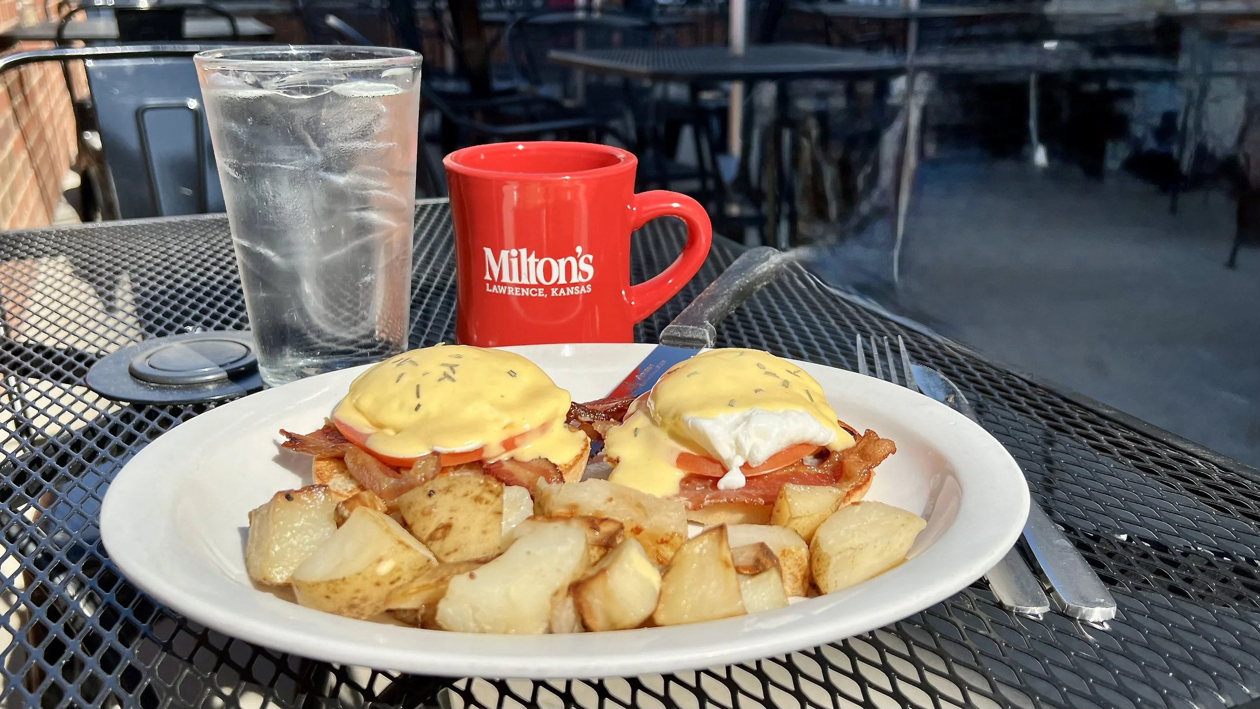 Two perfectly poached eggs nestled on a toasted English muffin, accompanied by crispy bacon and fresh-sliced tomato, all topped with our velvety, homemade hollandaise sauce and served with golden homestyle potatoes on the side.
