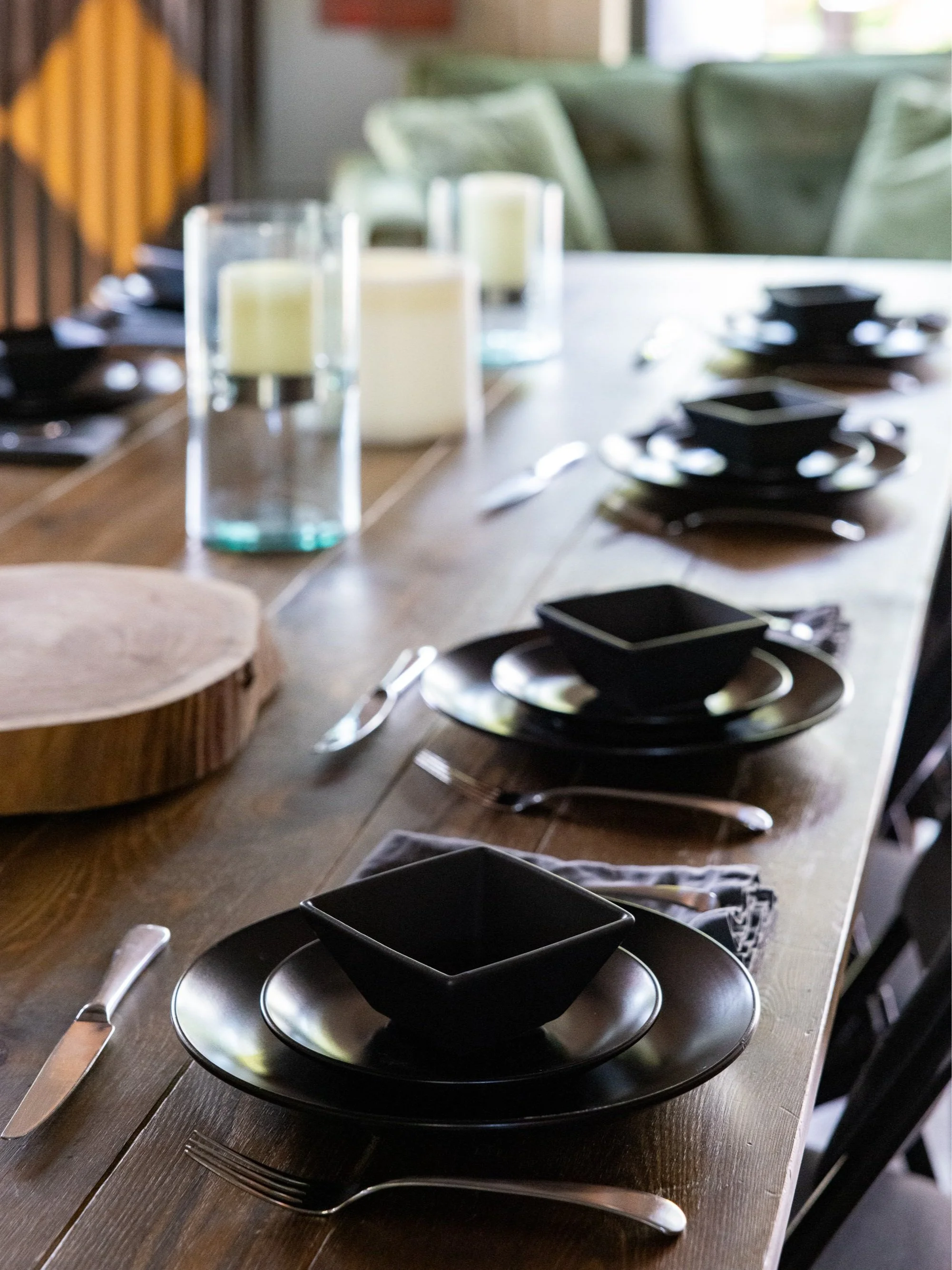 Table set with black dishware, candles, and place settings for a women-centered gathering at The Garage in Bingen, WA