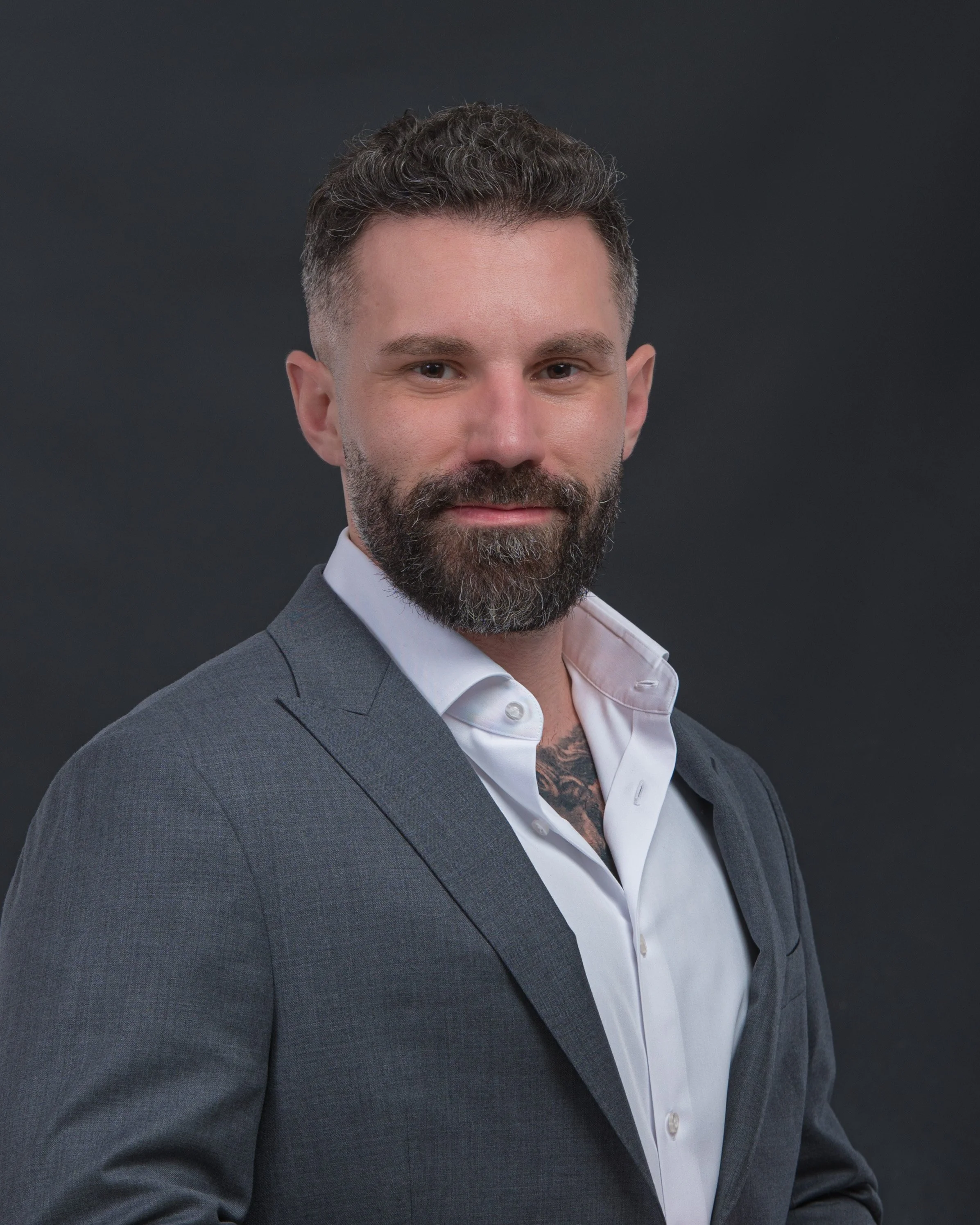 Man in a suit standing outside a building