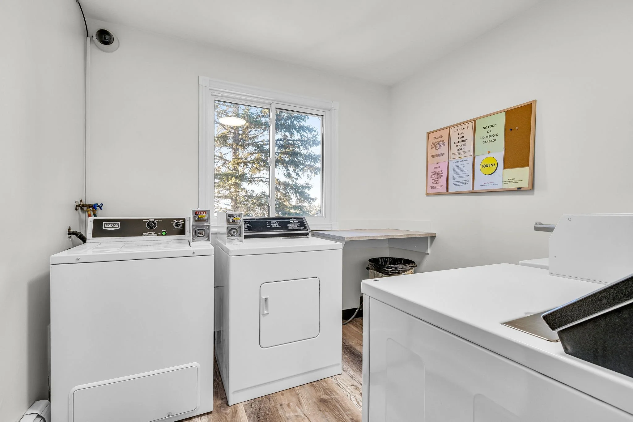 Laundry room with coin-operated washing machines and dryer